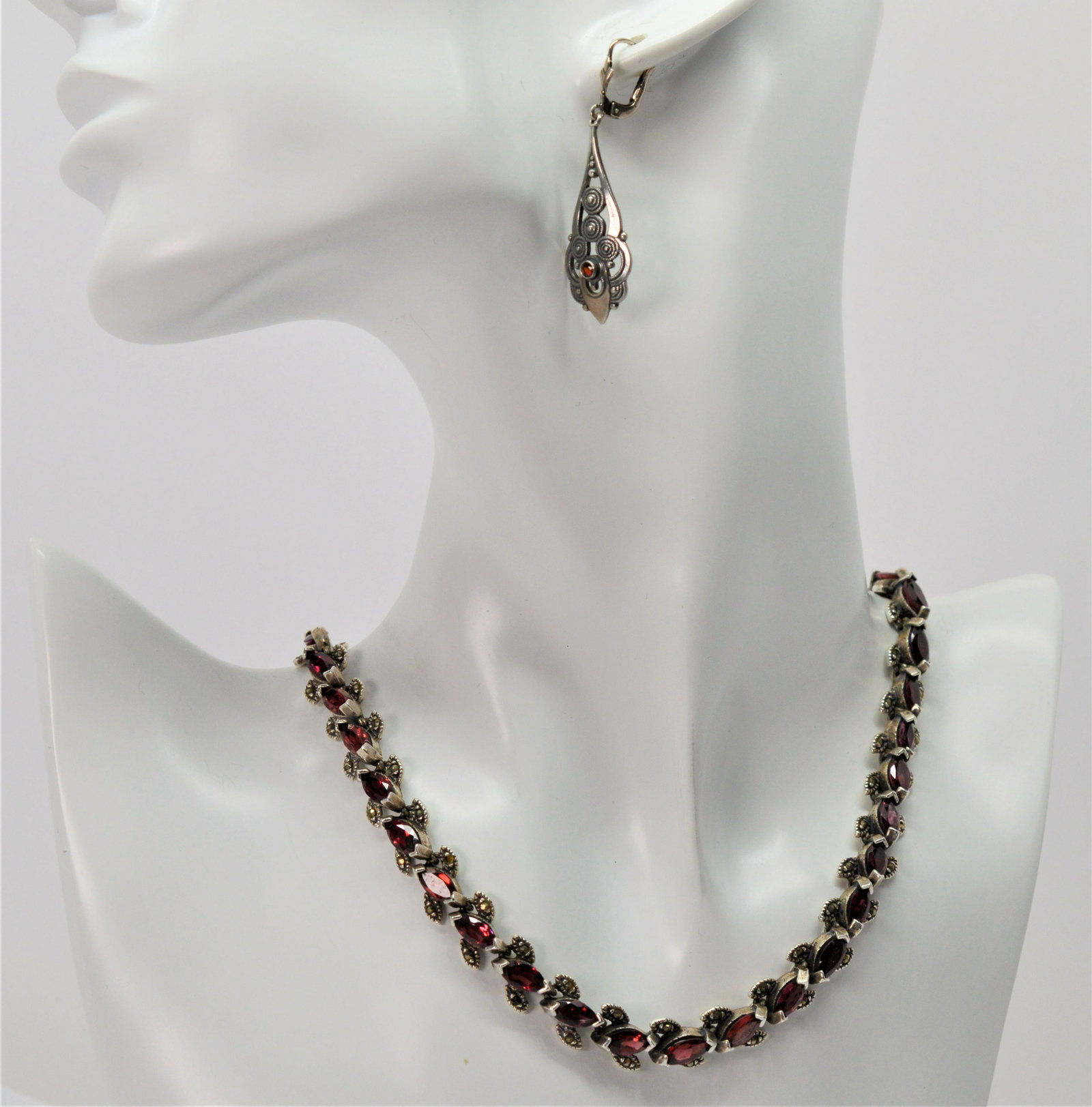 Garnet & Marcasite Statement Necklace with Earrins: 15" long necklace; 1.75" long earrings. 15" marquise-shaped garnet stone statement necklace w marcasite accent leaves set in .925 sterling silver; coordinating drop earrings w garnet stone; 31.2 dwt T