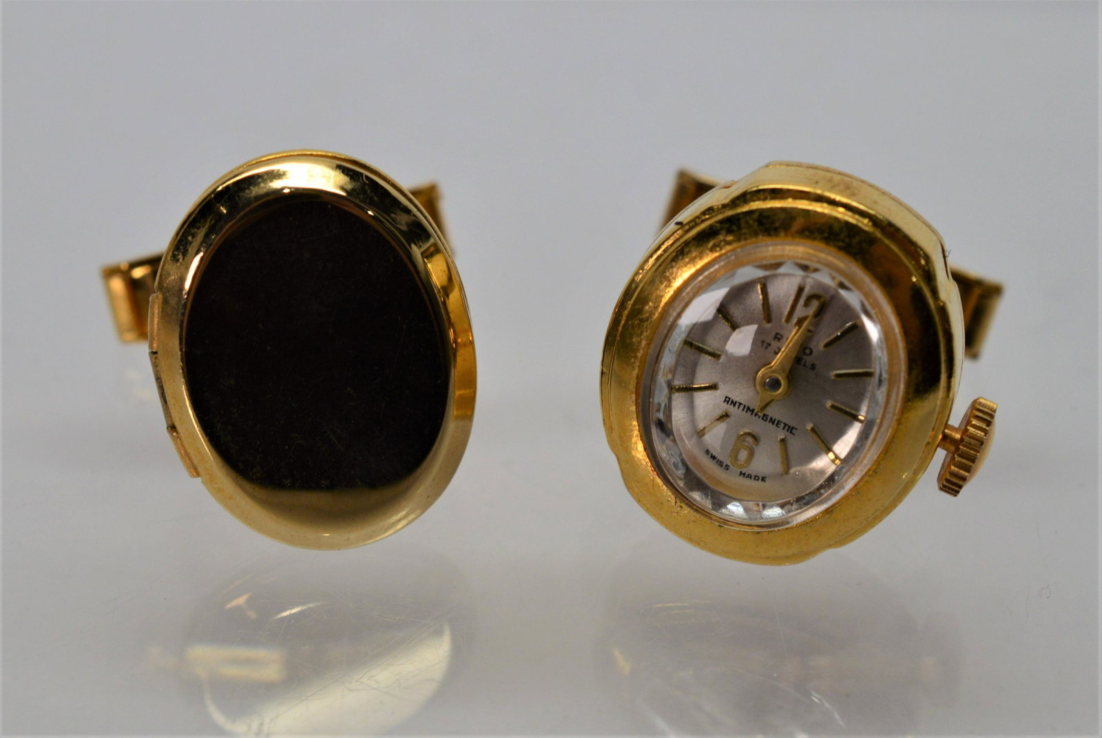 Unique Swiss Vintage Clock and Locket Cuff Links: Unique pair of 10K gold plated cuff links. One is a swiss-made time piece, the other is a locket, patent 2920363, 8.8 TW 20 x 16mm