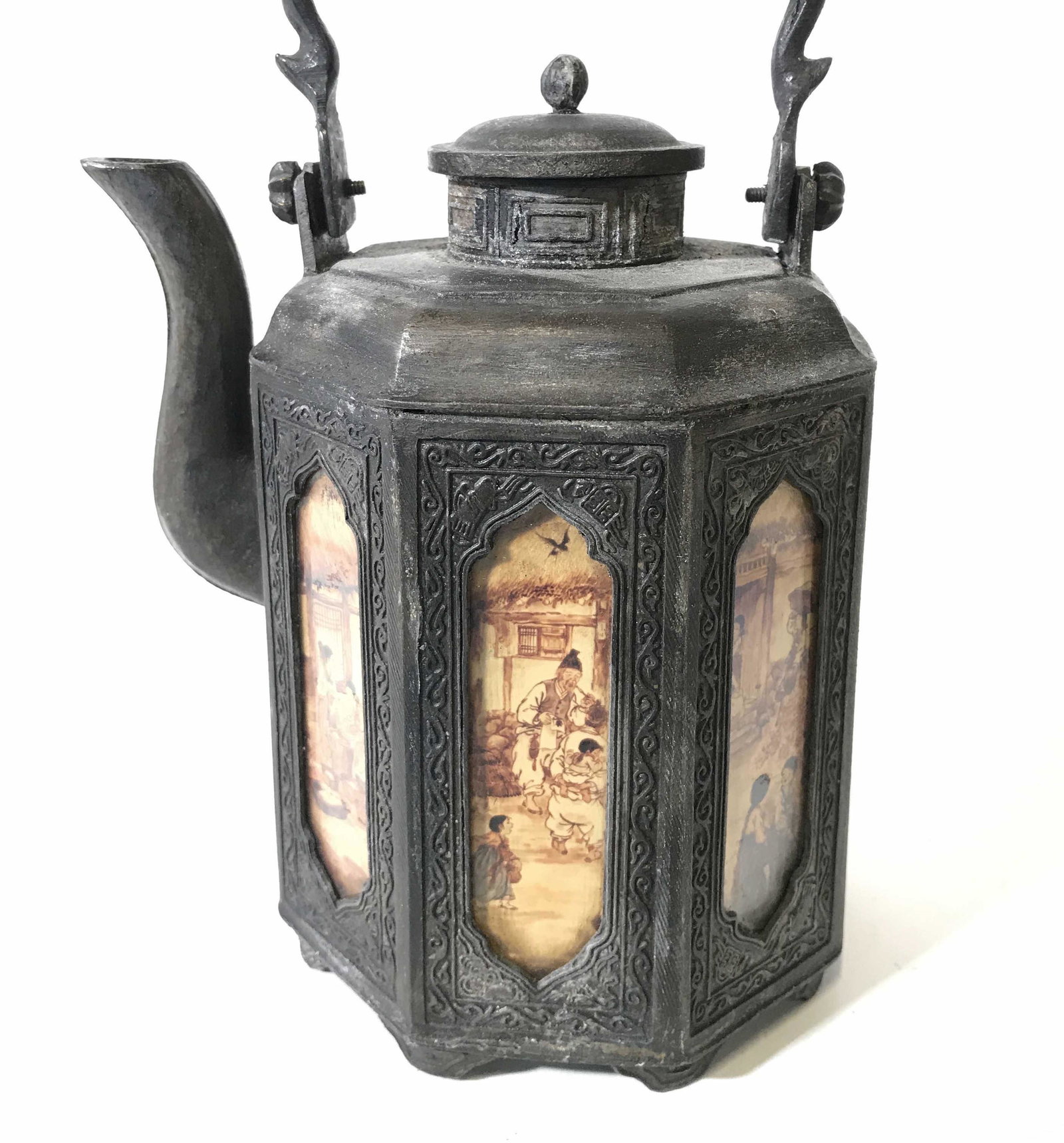 Antique Chinese Metal Teapot W Handle: Teapot is vintage possibly antique. Teapot is metal. Piece has lid and handle. Piece has multiple scene depictions around perimeter. Piece measures approximately 9 inches tall 5.5 inches wide with spo