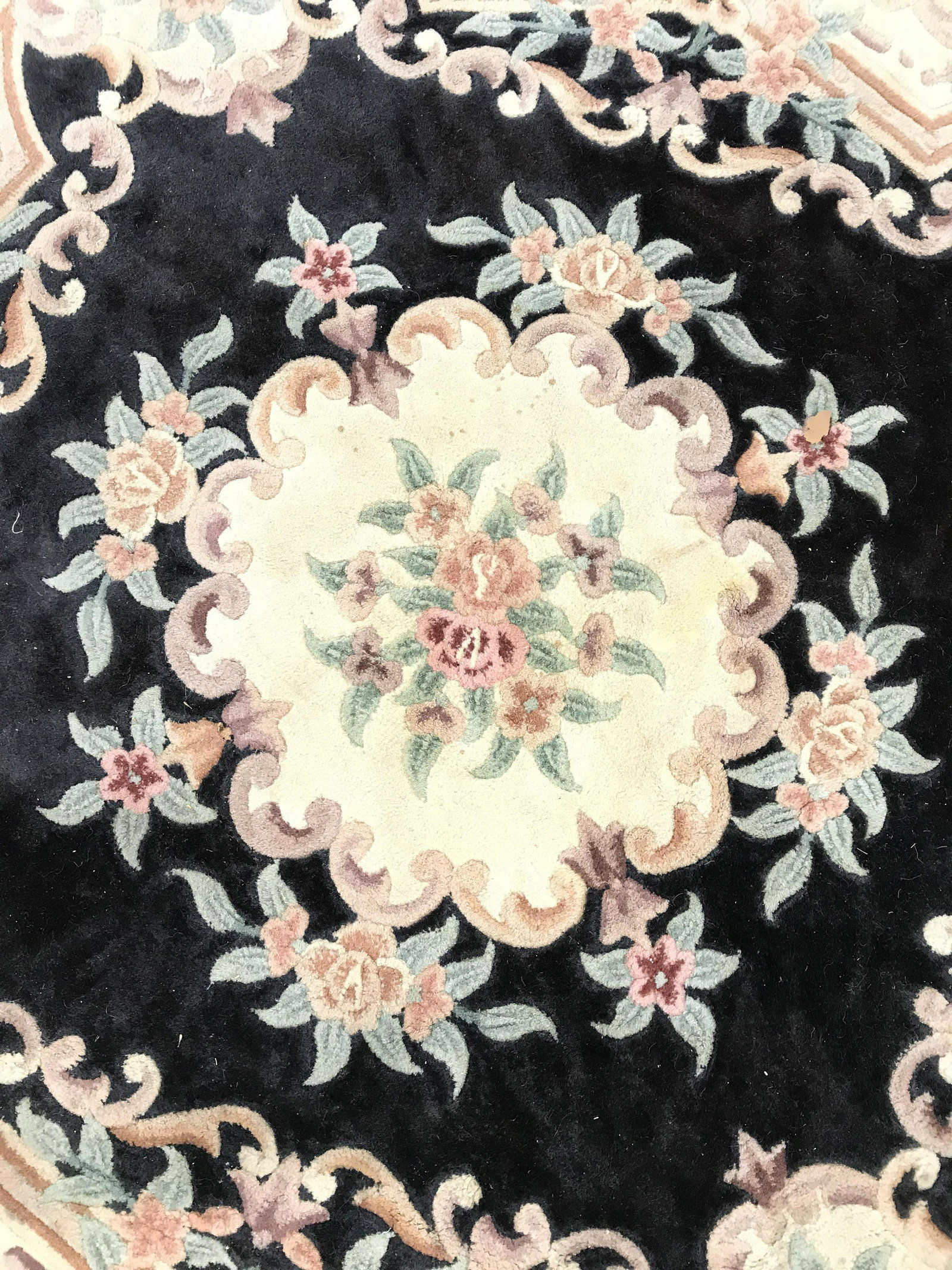 Floral Detailed Aubusson Wool Pile Octagonal Rug: Rug is wool and fringed. Appears to be vintage. Piece contains intricate multi toned floral and leaf detail. Rug is wool pile. Rug has octagonal shape. Piece measures approximately 95 inches wide. Rug