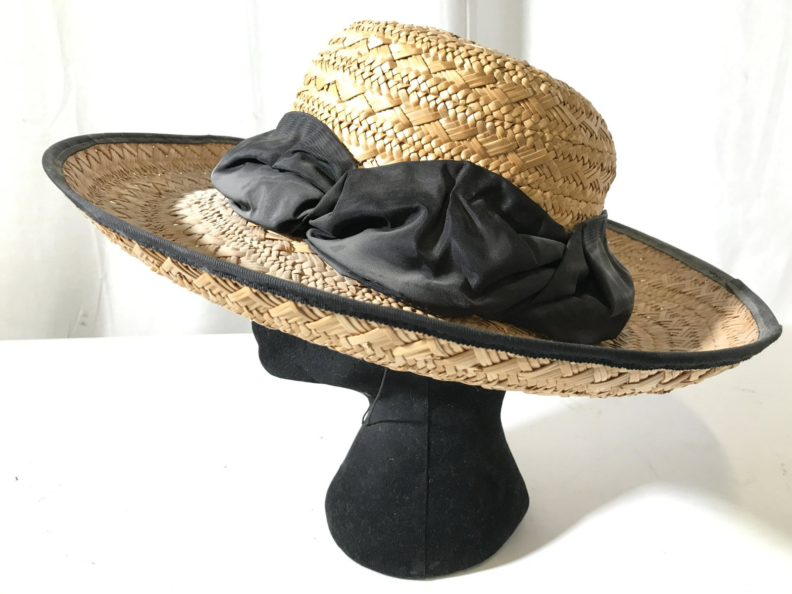 Woven ERIC JAVITS Outdoor Sun Hat W Chin Cord: Tag on interior of hat reads ERIC JAVITS. Piece is tan toned with woven structure. Piece has black toned edge of brim & black toned hat ribbon around crown. Hat has chin cord. Hat, sun hat, home decor