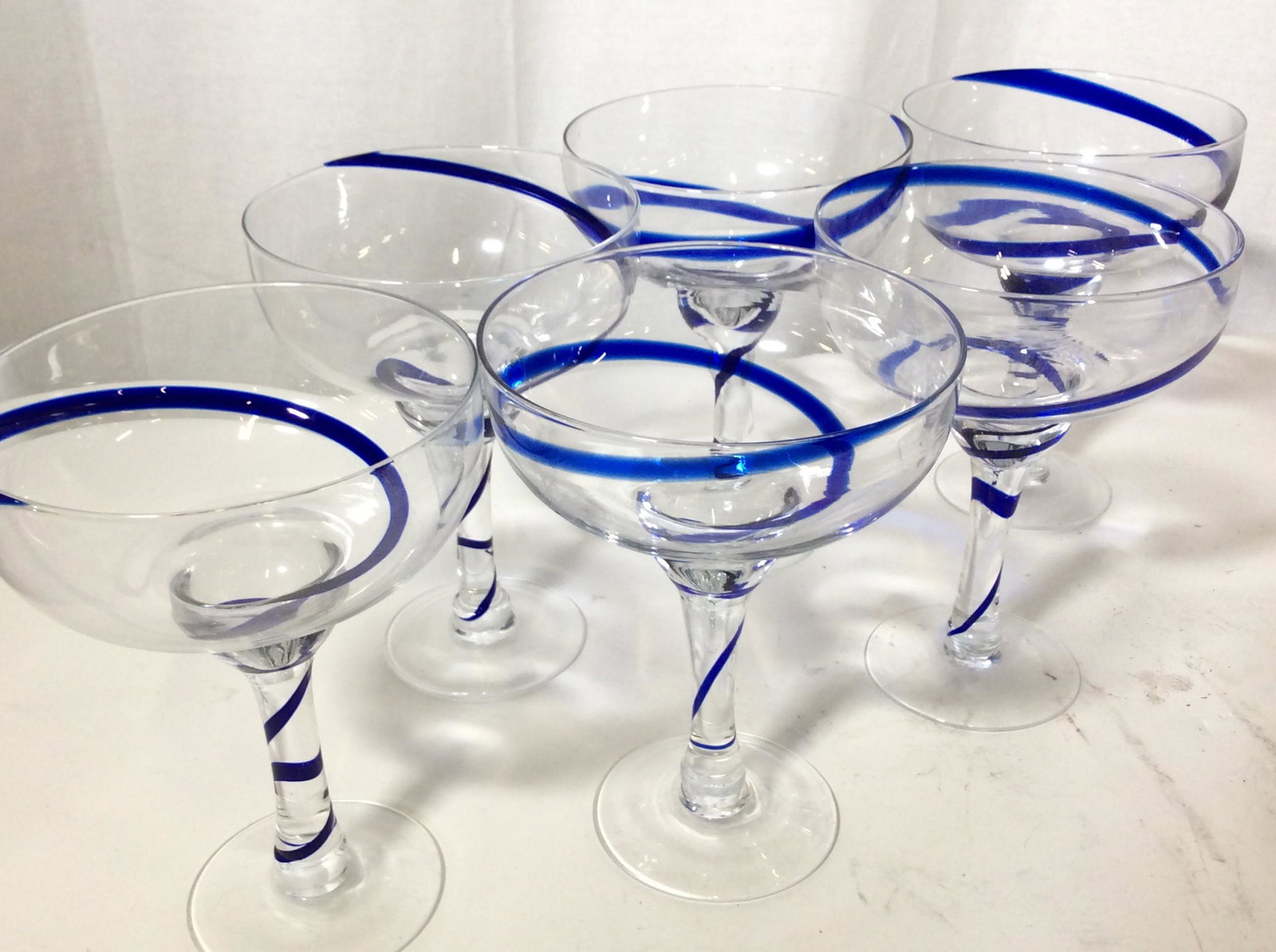 Set 6 Colbalt Swirl Margarita Barware Glasses: 6 Margarita, Daiquiri stemware glasses. Cobalt blue accent swirl in glass. Thick stem, measures 5.25 in diameter, 7 in ht. Glass Stemware, Barware, daiquiri, margarita glasses, cocktail-ware, Vessel w
