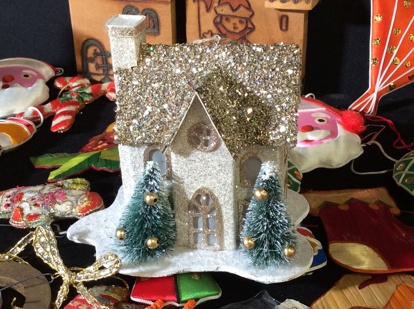 Large lot Vintage Christmas Ornaments: Lot depicts Ornaments c. 1960s, Collection Of Raffia decorations, Lustrous Glass Ornaments, Collection Of Cardboard Santa Ornaments, Wood Figural train Set, Porcelain manger with Franciscan Friars , d