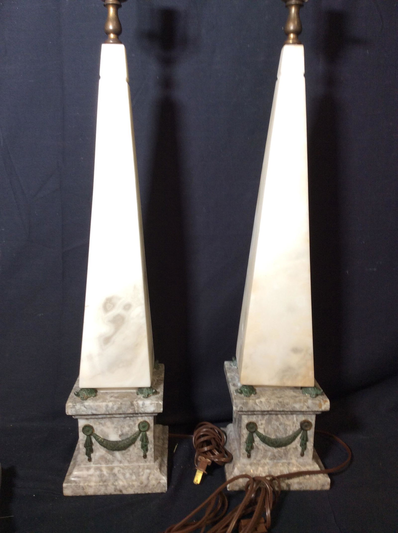 Pair Natural Stone Obelisk Lamps: Polished grey Conglomerate Square base with cream alabaster ( possibly) Obelisk. Stands 36 in tall with light harp. Weighted pieces. some stone scratch or abrasion to stone. Measures 5.5 in wide. Neoc