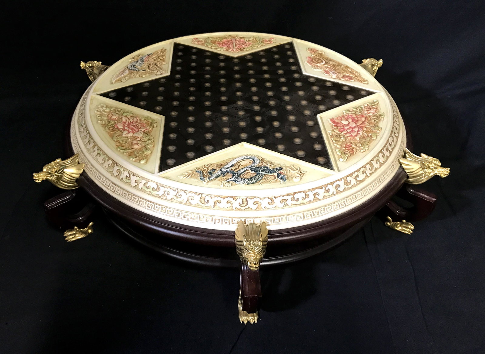 Vintage Hand Painted Chinese Checker Board: Vintage Chinese checker board. Board sits on a wooden, footed platform. Each foot is crafted from brass and resembles a clawed foot, several brass dragon heads decorate the edge of the board, one head