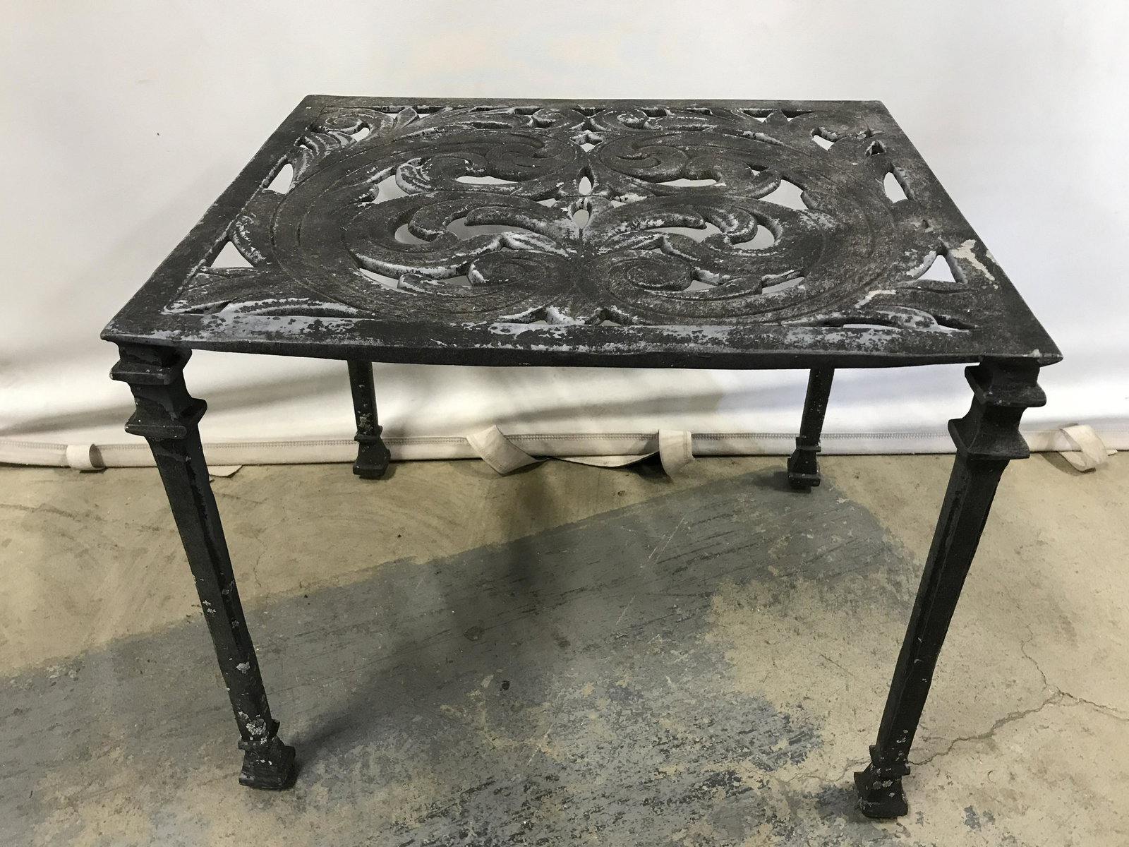 Vintage Outdoor Side Table: Vintage outdoor side table. Crafted from white metal. Measures approx 16.25 inches H, 19.25 inches W, 15.5 inches deep. Wear is consistent with age and exposure. Outdoor furniture, side table, vintage