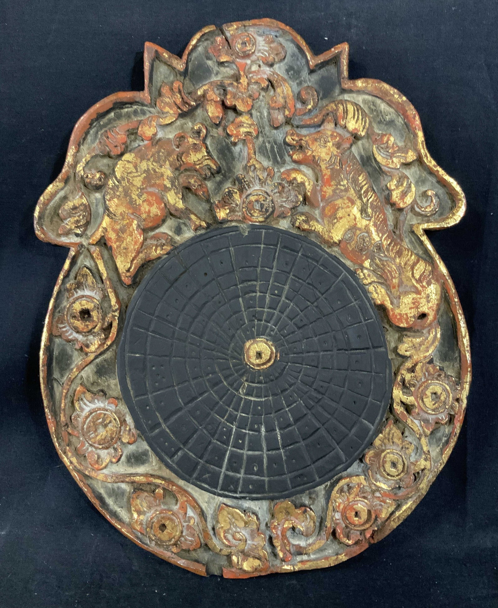 Far East Asian Wood Sculpture: Far East Asian Wood Sculpture, Possibly Indonesian, no apparent inscriptions or signatures, two animals and vegetal designs over mandala like structure, Gold toned, black, and red pigment, measures 14