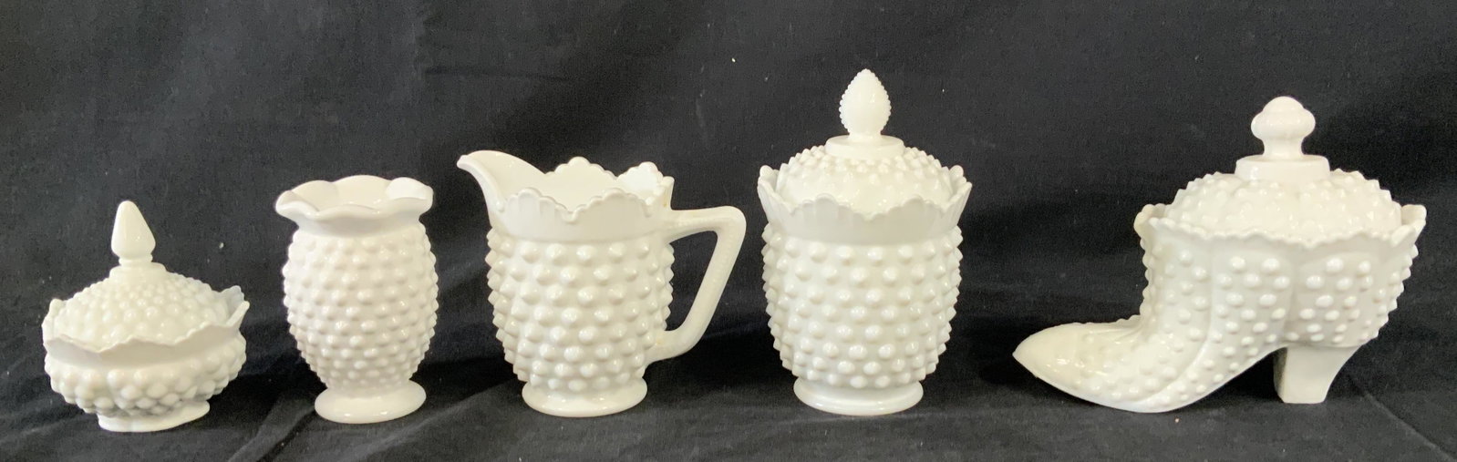 Lot 5 Taiwanese Milk Glass Vessels: Lot 5 Taiwanese Milk Glass Vessels, inscription to base reads ‘Made in Taiwan’, embossed design, shoe vessel measures 5 inches tall x 6 inches at widest point, smallest vessel measures 3 5/8 inche