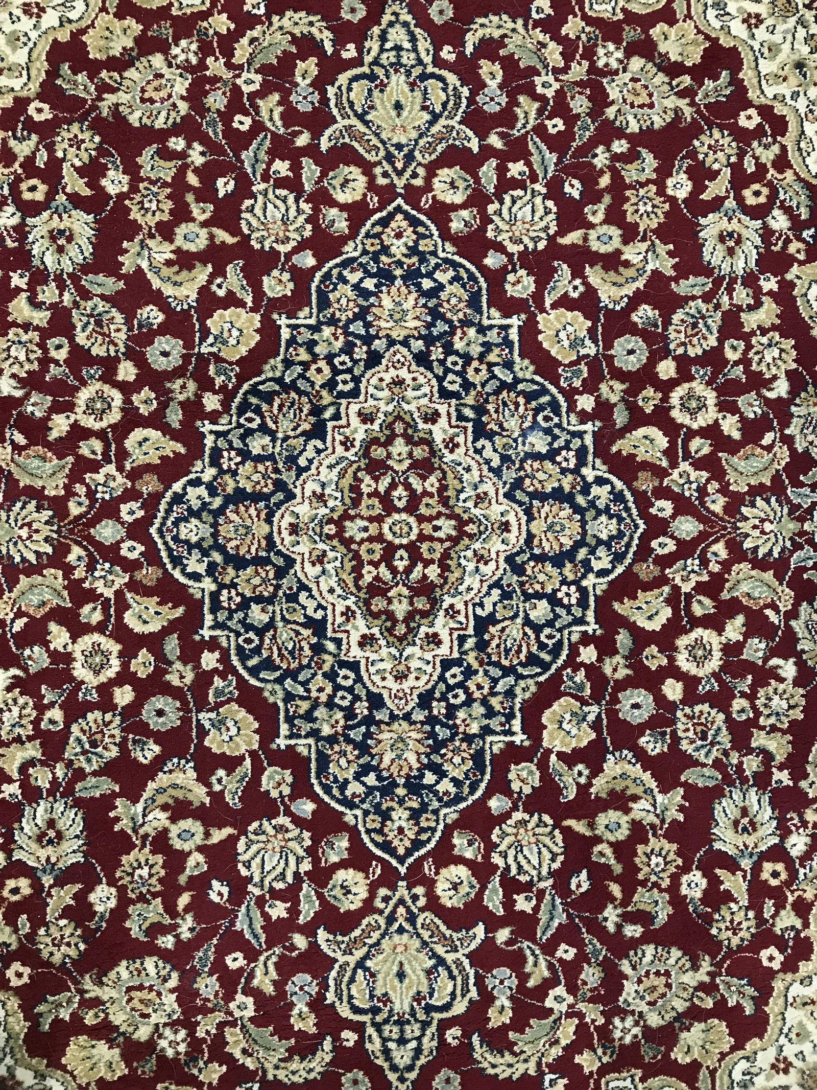 CLASSIC Belgian Olefin Rug: Label on underside reads CLASSIC Made in Belgium, Olefin. Rug contains intricate multi toned floral, leaf and vine detail. Piece measures approximately 91 inches long 62 inches wide. Rug, carpet, area