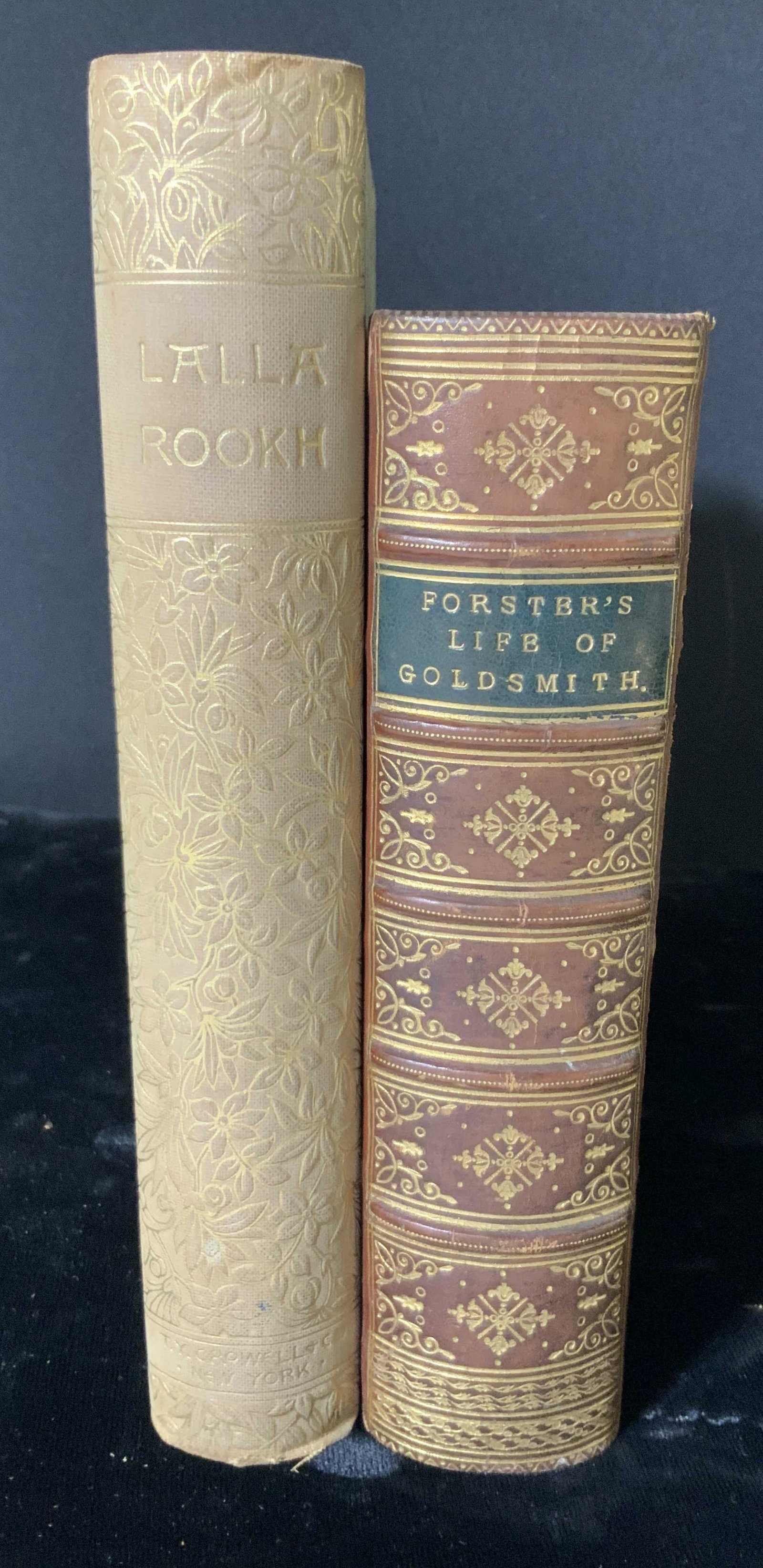 Lot of 2 Decorative Antique Novels: Lot of 2 antique hardcover books in good antique condition. Titles are: LALLA ROOKH (Thomas Moore) & THE LIFE AND TIMES OF OLIVER GOLDSMITH (John Forster). Height 6.5 in. Width approx. 4.5 in. Antique