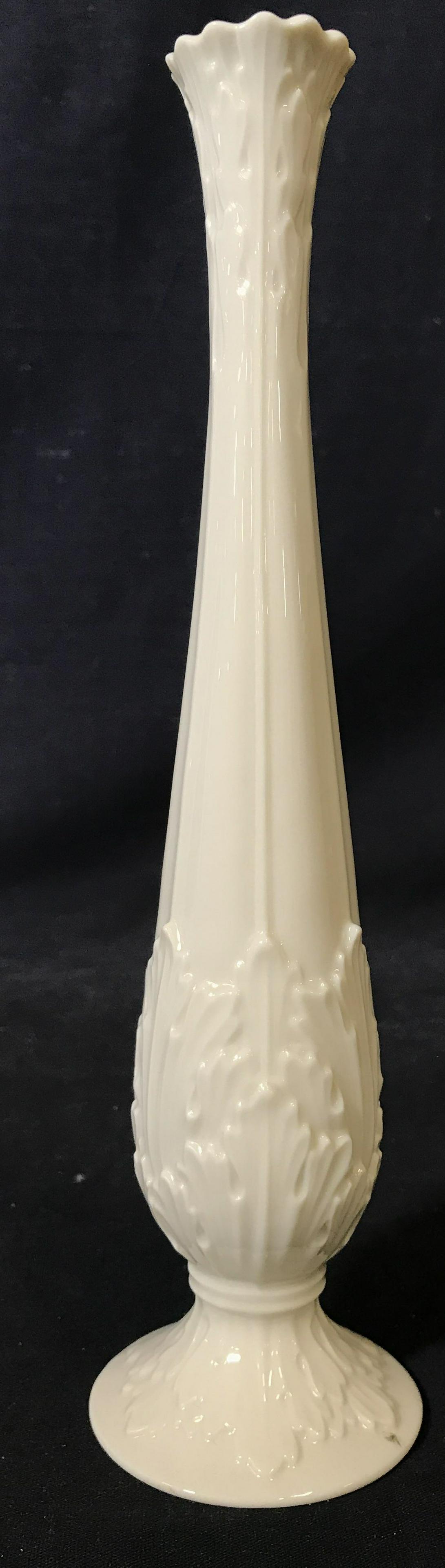 Cream Toned Pedestaled LENOX Vase: Vase is cream toned and porcelain. Underside is marked LENOX. Vase has low pedestal foot base, Piece measures approximately 11 inches tall 2.75 inches wide. Vase, pedestaled vase, LENOX VASE, Porcelai