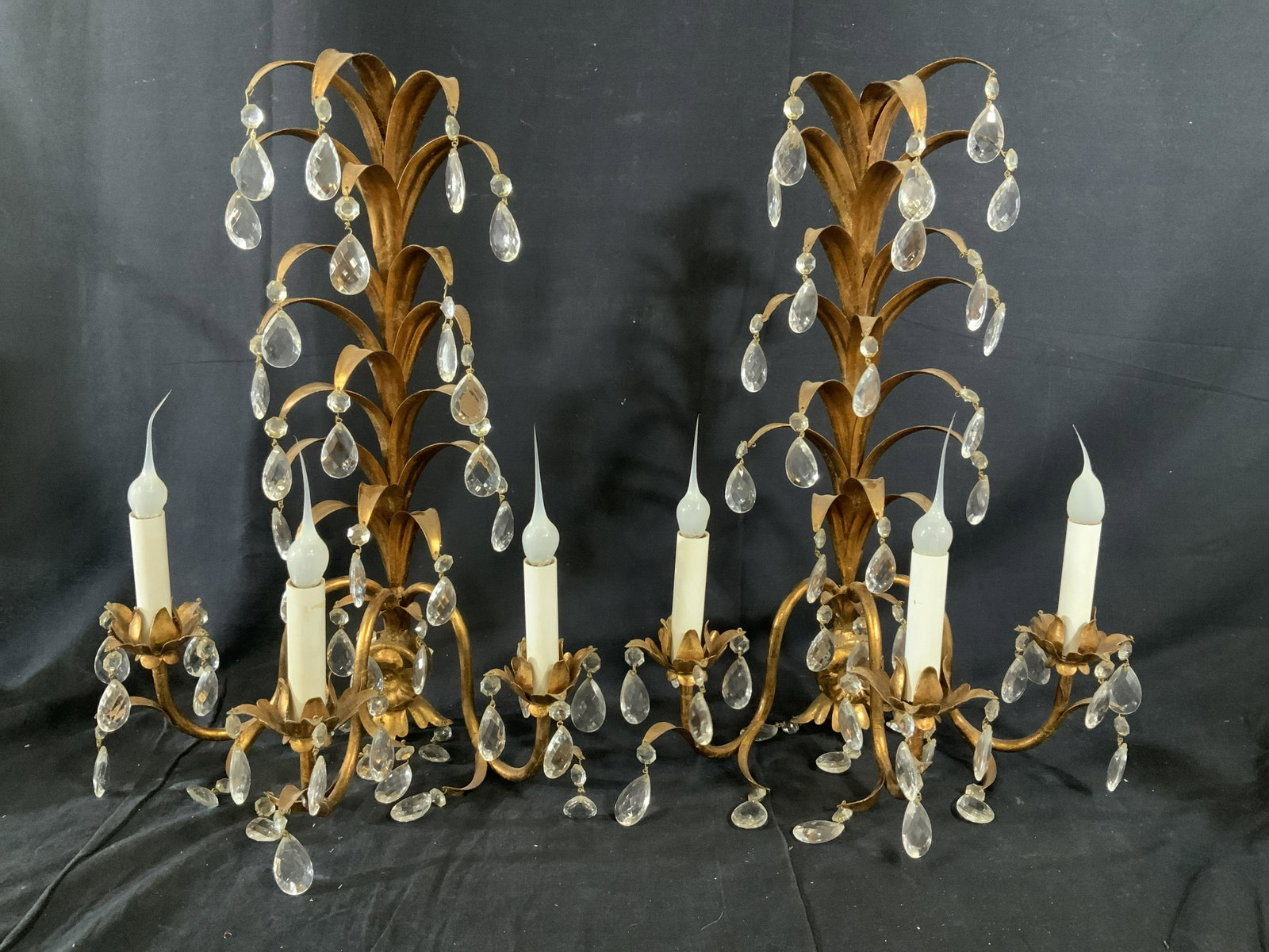 Pair Grand Italian Wall Sconces W Prisms: Pair Italian Wall Sconces, possibly brass, inscription to piece reads ‘Made in Italy’, palm tree like design, hanging composite pendants, both measure 20 1/4 inches tall x 14 1/4 inches wide, some