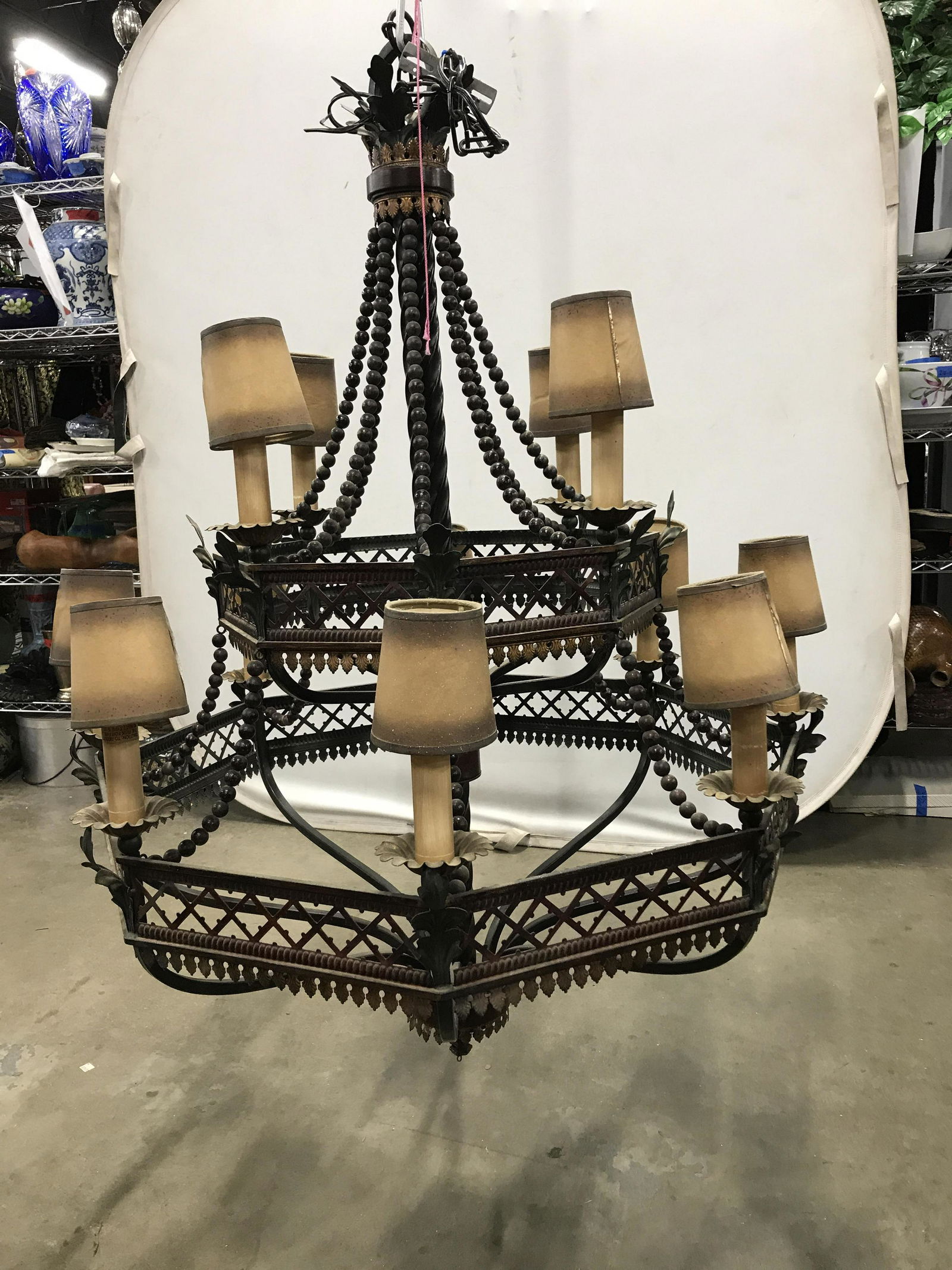Vintage Grand Metal Beaded Chandelier: Vintage grand, oversized chandelier, possibly antique. Central column is twisted. Chandelier was hand painted. Each socket resembles a candle, leaf like detailing decorates each tier of lighting, stra