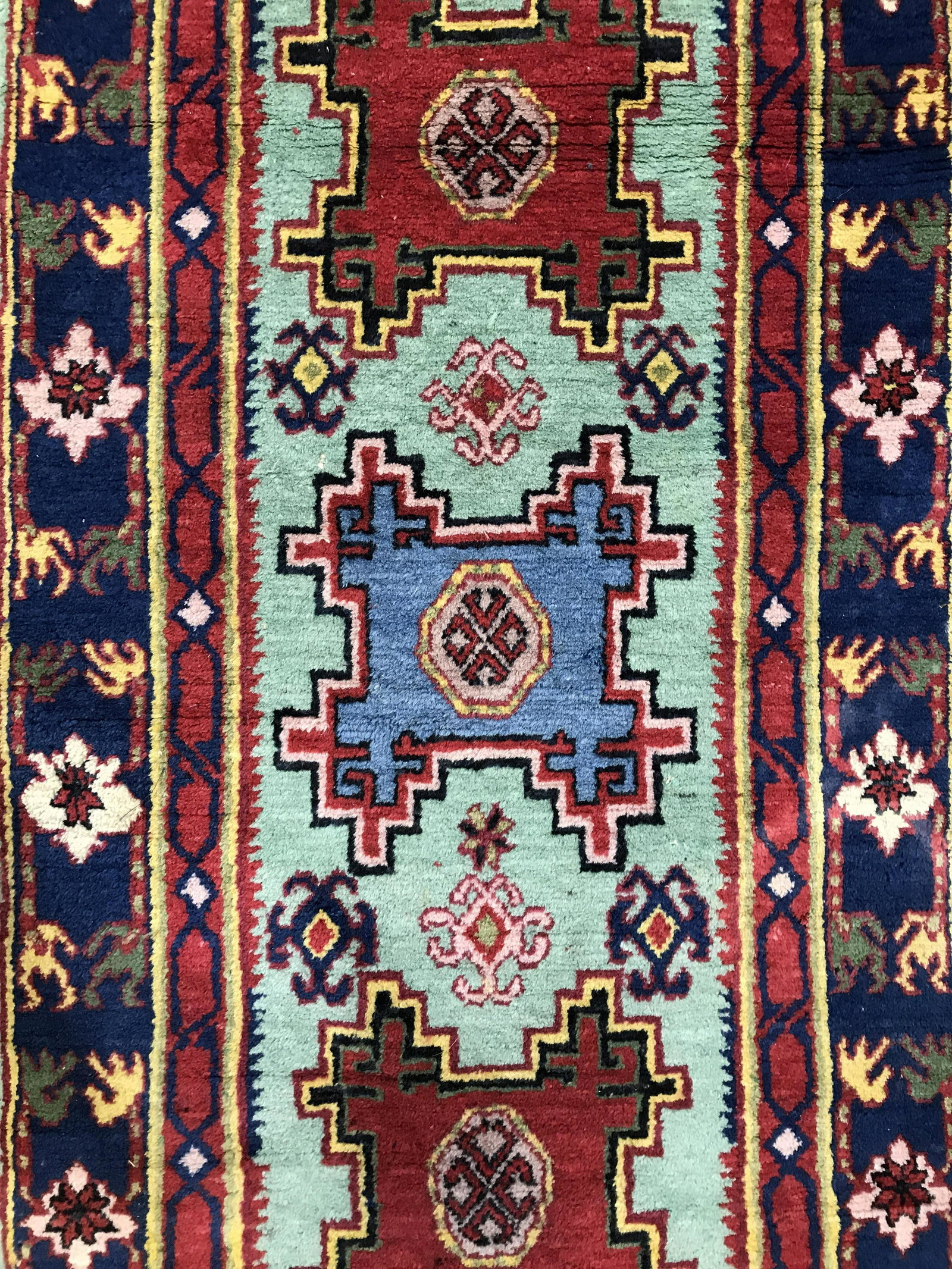 Vintage Handmade Turkish Wool Runner: Runner is wool and handmade. Piece contains intricate multi toned geometric detail. Rug is fringed. Piece is vintage possibly antique. Measures approximately 100 inches long 28 inches wide. Rug, runne