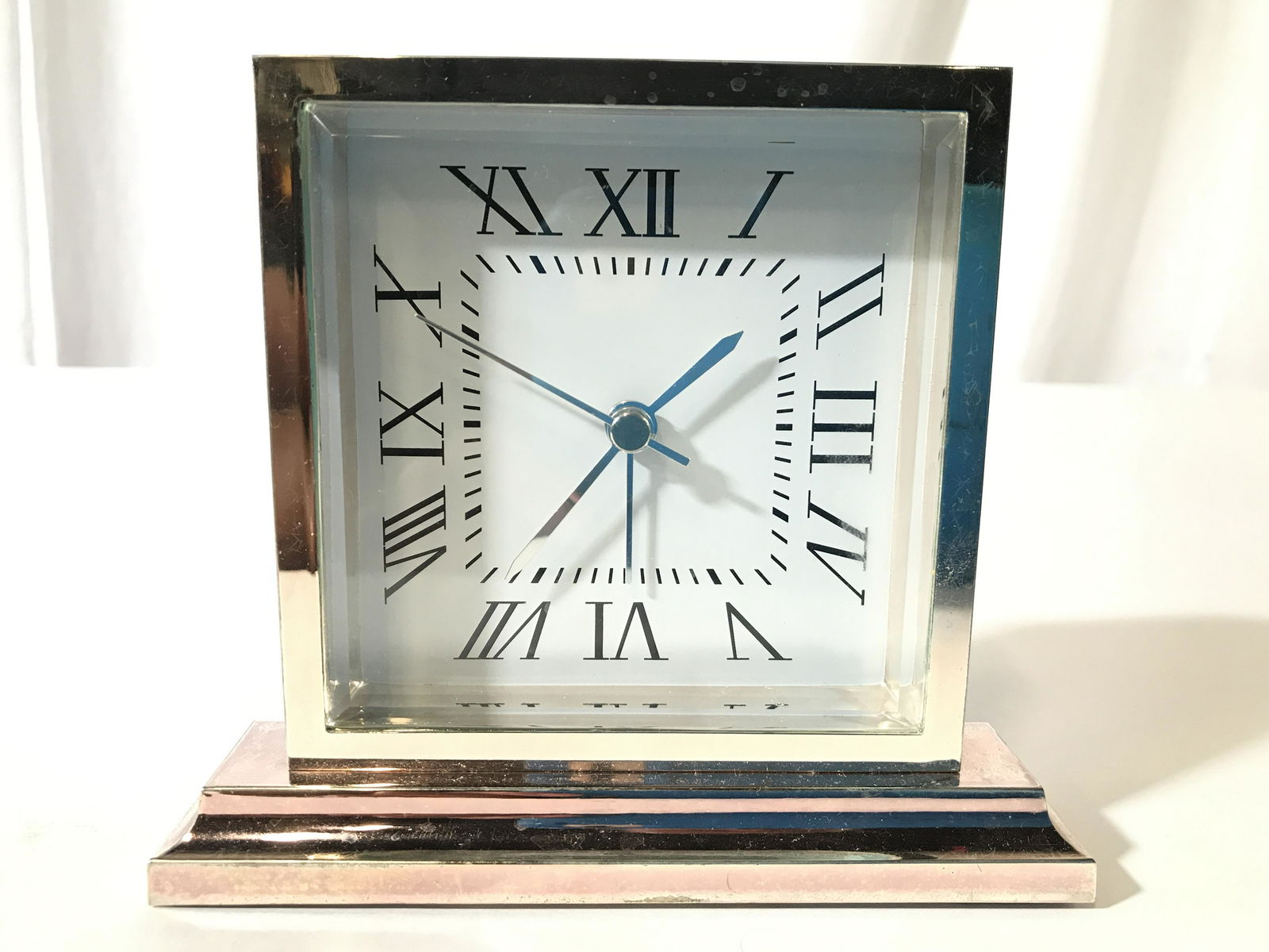 RESTORATION HARDWARE Desk Clock: Underside of piece has label which reads RESTORATION HARDWARE. Piece is metal with glass clock face cover. Clock face is white with black toned Roman numerals. Piece measures approximately 5 inches ta