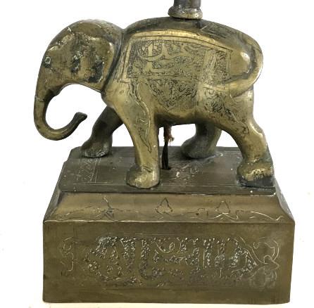 Vintage Etched Brass Elephant Figural Lamp: Lamp is gold toned and brass. Piece is vintage possibly antique. Piece has etched relief detail. Lamp contains elephant t Figural standing on pedestal. Piece measures approximately 10 inches tall 5 in