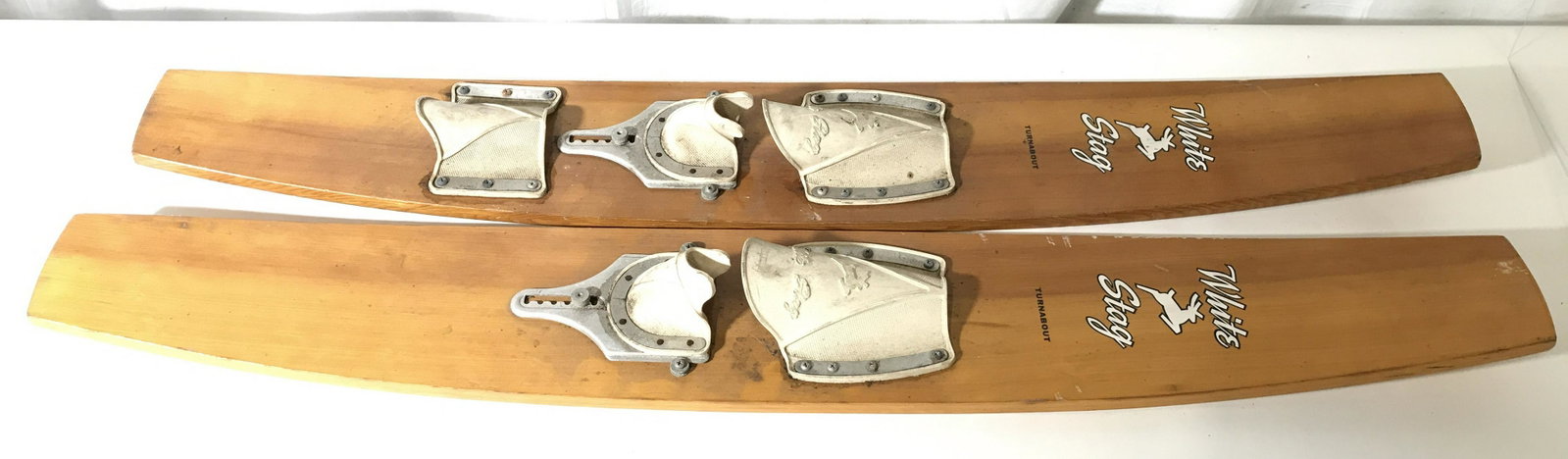 WHITE STAG Wooden Water Trick Skis: Trick skis are marked WHITE STAG TURNABOUT. Each are wooden. Each have cream toned foot fasteners. Each measures approximately 49 inches long 7 inches wide 3.5 inches tall. Water skis, trick skis, woo