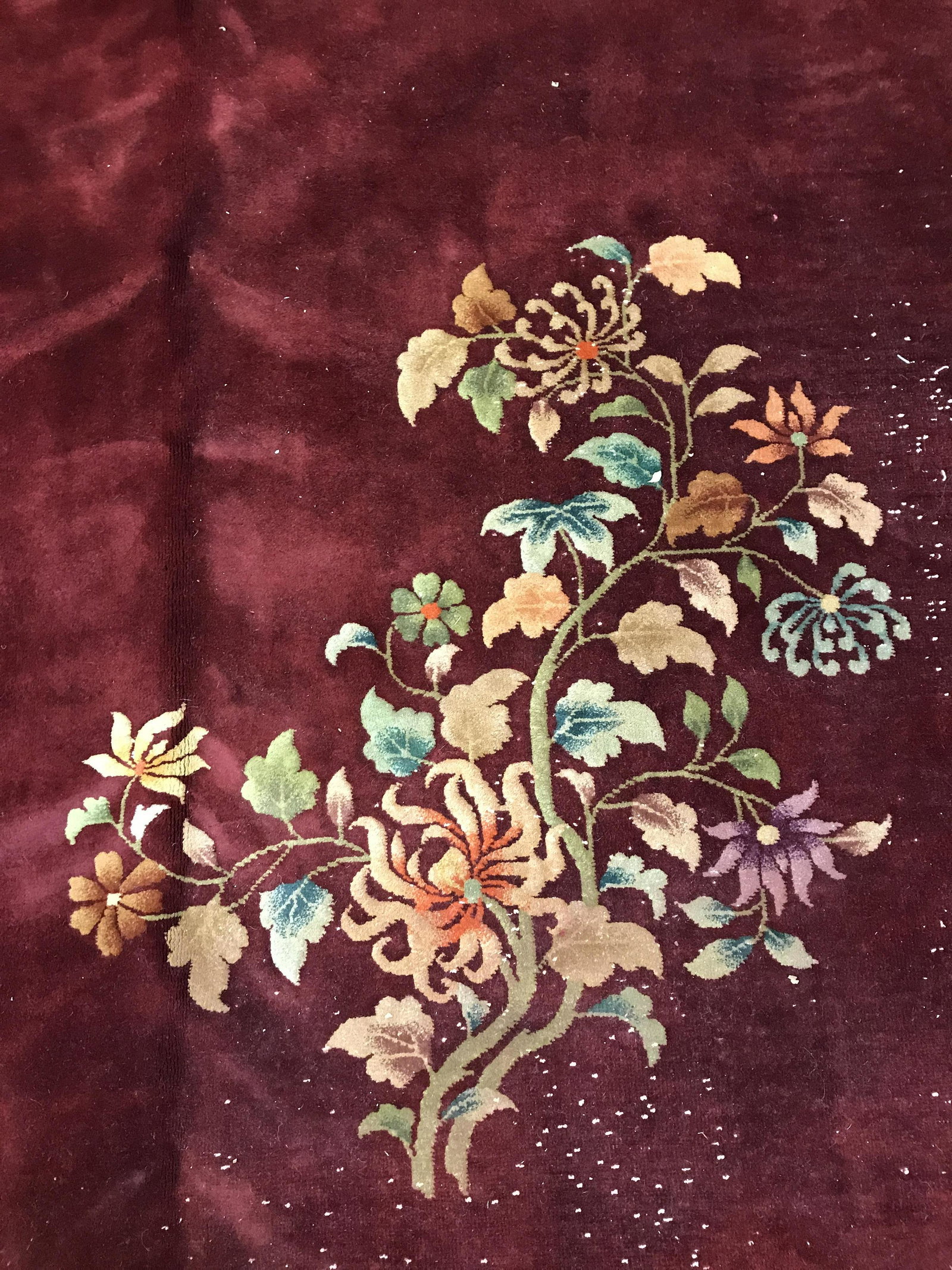 Vintage Chinese Art Deco Handmade Wool Pile Rug: Rug is wool and handmade. Piece contains multi toned floral & leaf detail. Rug has cranberry base tone. Piece measures approximately 140 inches long 106 inches wide. Rug, carpet, area rug, wool pile r