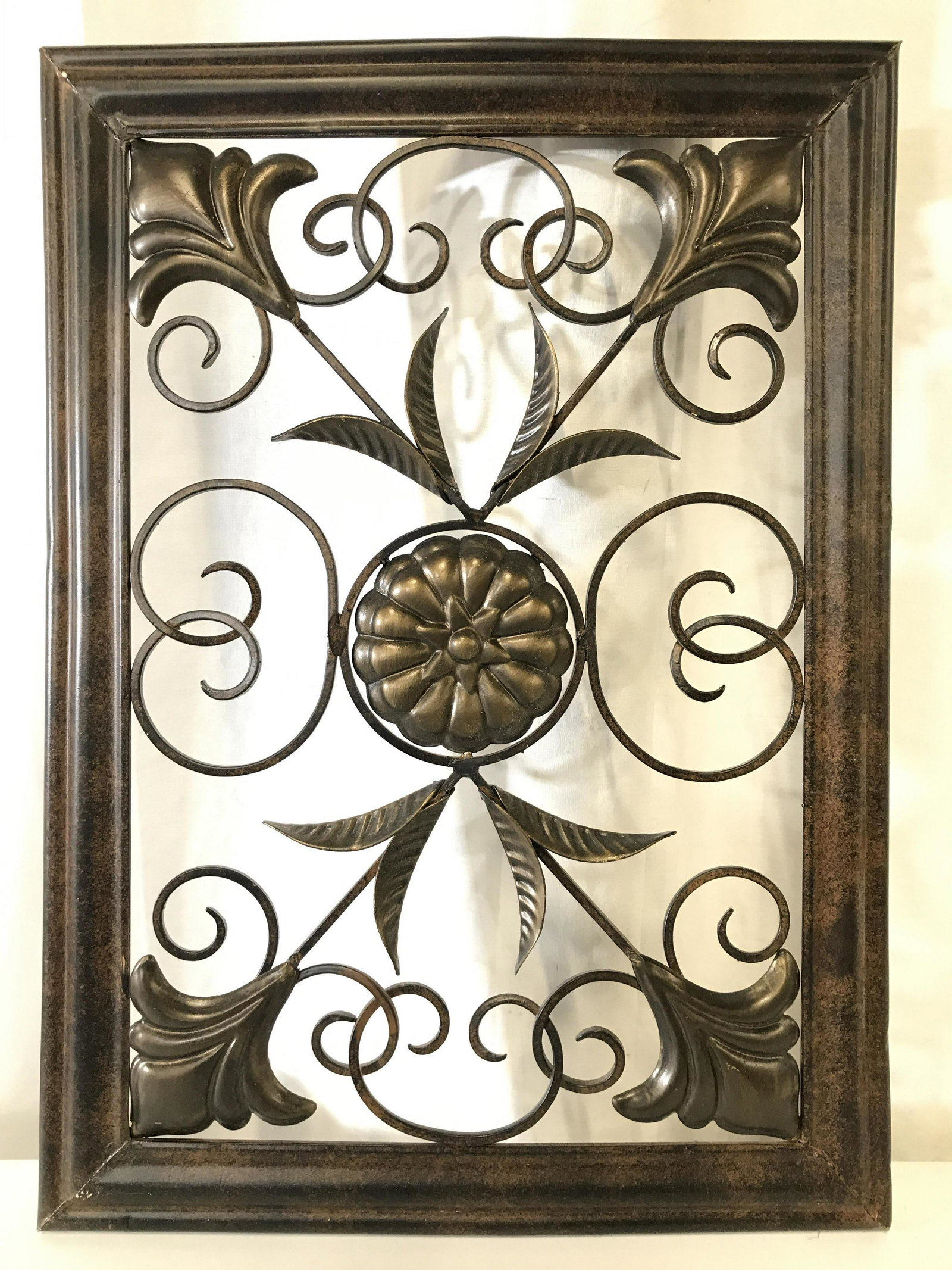 Pair Metal Wall Decor Accessories: Lot includes 2 wall decor pieces. Each are bronze toned and metal. Both contain c curve, floral & leaf structures. Each measures approximately 18 inches tall 13 inches wide. Wall decor, wall accessori