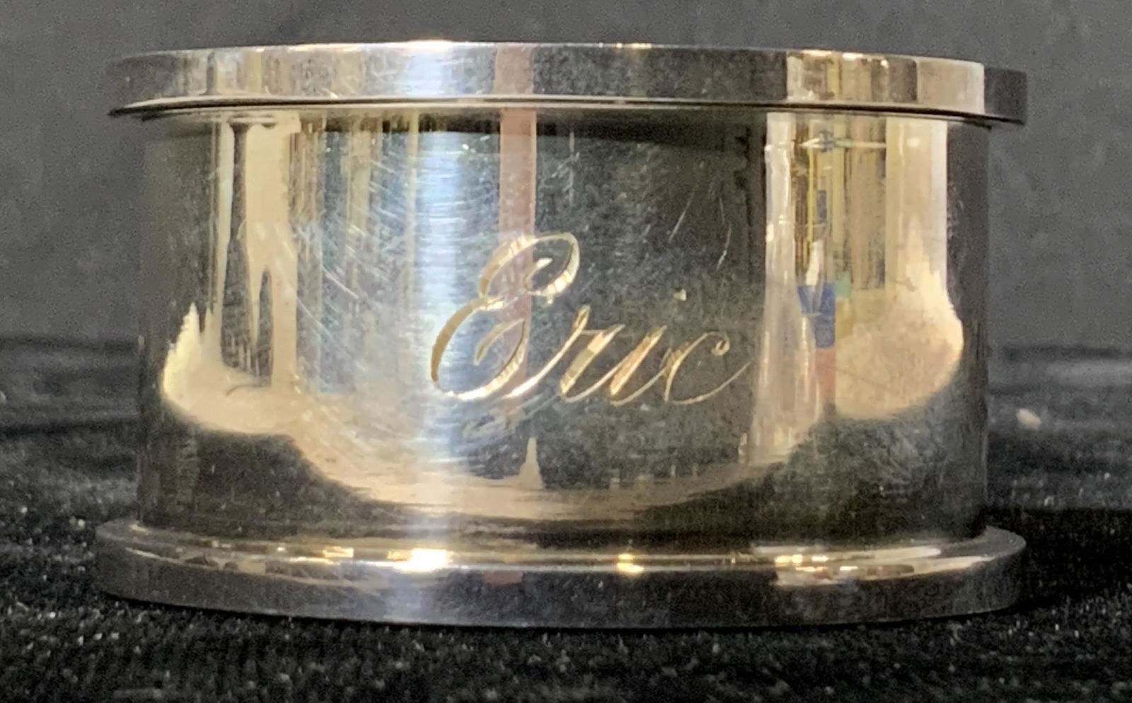 Polished Sterling Silver Napkin Holder: A sterling silver napkin holder engraved with the name ‘Eric.’ Hallmarked with an anchor, lion, and letter ‘S.’ Approx. 1.75 in. diameter Approx. 1 in. height Sterling silver, sterling silver