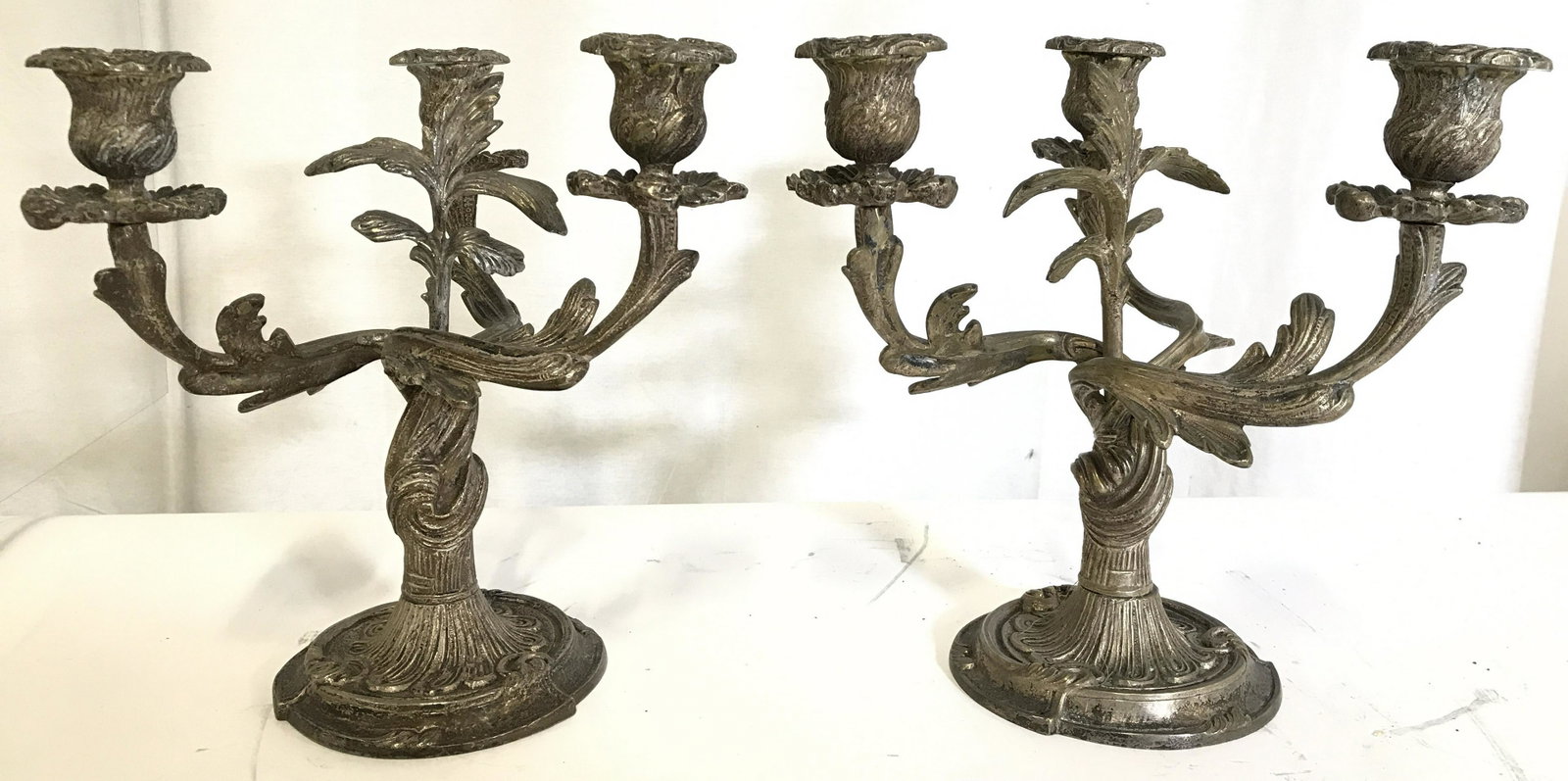 Antique 3 Arm Bronze W Silver Wash Candelabras: Candelabras Are antique. Each piece has 3 arms. Candelabras have vine and leaf detail. Bronze W Silver Wash Each measures approximately 10.5 inches tall 9 inches wide. Candelabras, candelabras, antiqu
