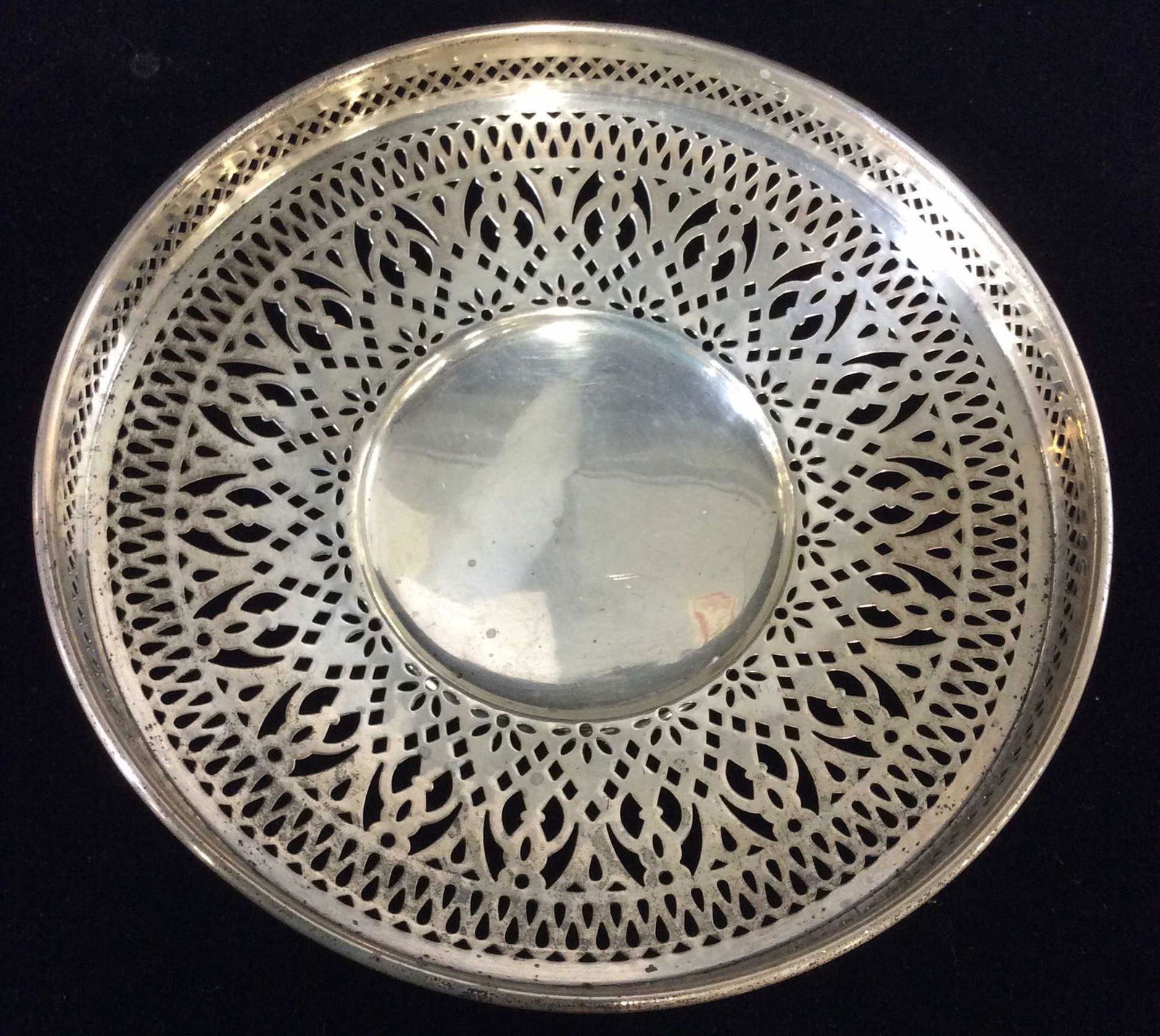 Edwardian MERIDEN Sterling Pierced Table Accessory: Pierced Shallow Bowl/ Dish with Edwardian Style Decor. 6 in. diameter. 1. 1/4 in. Ht. 3.59 ozt. Underside Has spread eagle hallmark with letter ‘m’ reads ‘STERLING 358’ . Possibly antique. No