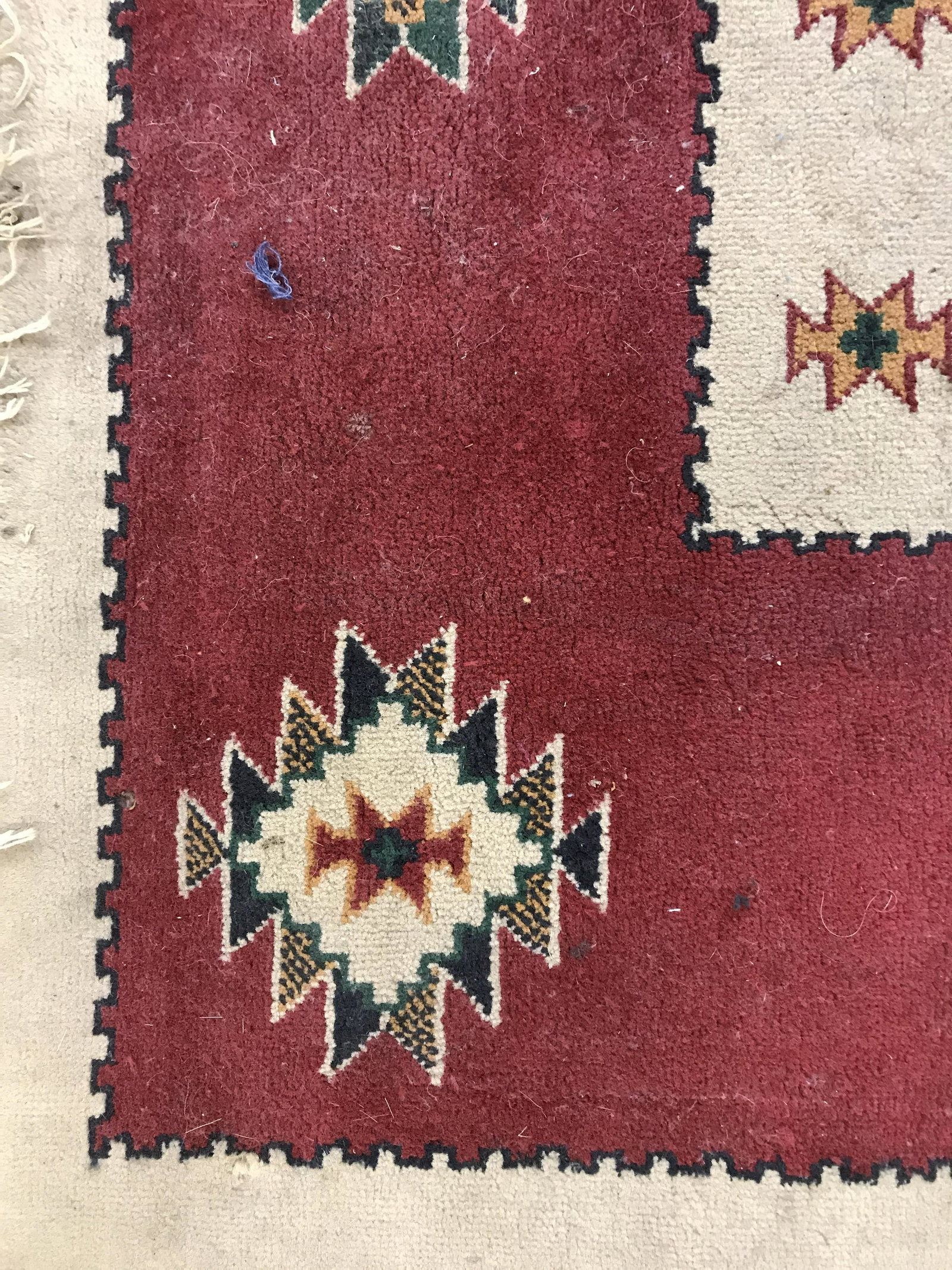 Vintage Wool Area Rug: Vintage wool area rug, decorated with a multi toned southwestern-American theme. Ends are frilled. Measures approx 90 inches long, 65 inches W. Wear is consistent with age and use. Vintage decor, vint