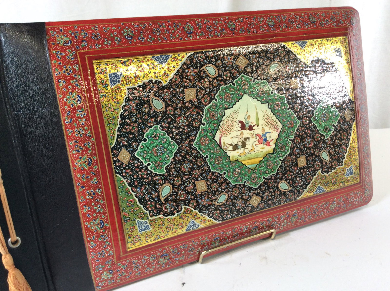 Vintage Lacquered Asian Photo/sketch Book: Hand painted Keepsake Book, Mongolian Warrior Motif, heavily Decorated with florals with East Asian Patterns. red border, with gold, navy and green decor. Leather Bound, black paper pages with decorat