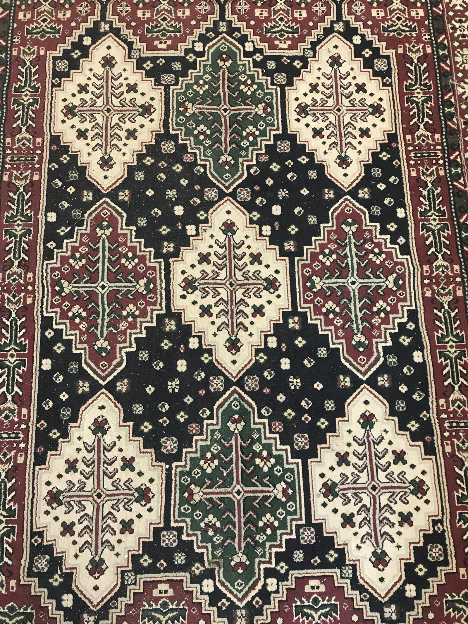 Vintage Persian Style Wool Area Rug: Wintage wool rug. Persian style rug, ends are frilled. Multi toned geometric patterns decorate carpet. Measures approx 114 inches Long, and 79 inches W. Wear is consistent with age and use. Vintage de