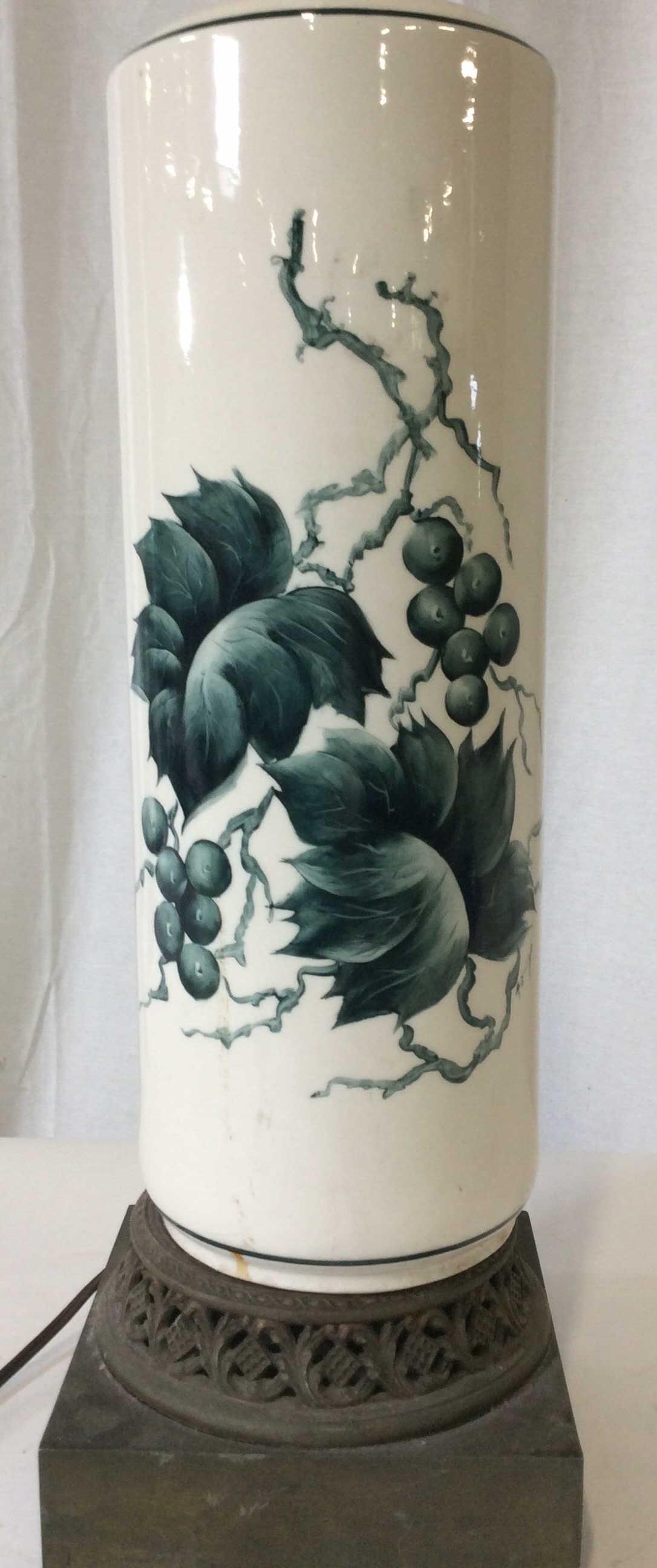 Vntg Porcelain And Metal Base Table Lamp: Square metal base with pierced design, tubular Porcelain Pedestal with Hand Painted grape vine design. Large long light harp ( can be changed to lower profile if Designer Ed) tublular Brass finial. Ht