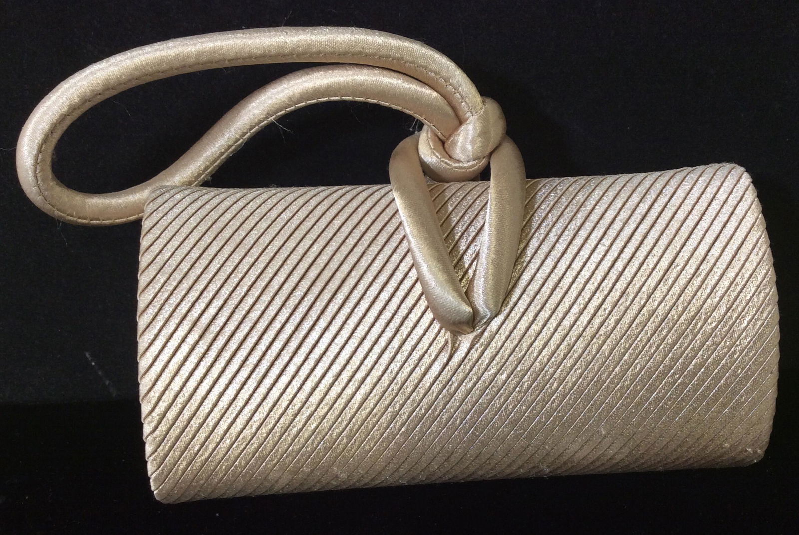 Caché Gold Ribbed Fabric Clutch Wristlet Bag: Labeled Caché brand, Hard Case Clutch Wristlet With plissé Gold toned metallic fabric on the diagonal. Tubular Shape, 6.5 x 3 in. Loop cord 4.5 in. drop. fashion accessories, clutch, wearable, purse