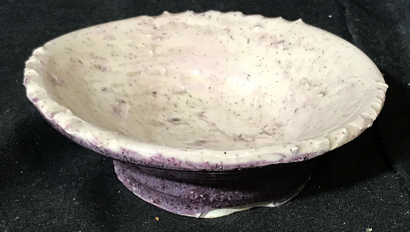 Signed Purple Ceramic Dish: Purple ceramic dish, handmade, interior black spots on pink and white, exterior a granite purple color, glazed dish, signed on the bottom reads Mandy, measures 5 inches in diameter, Signed, purple cer
