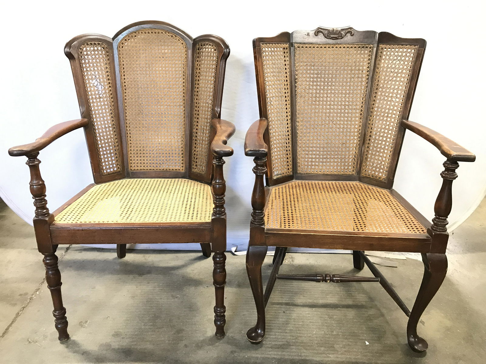 Lot 2 Vintage Carved Wooden End Chairs: End chairs are vintage. Each have carved wooden legs & 3 panel back. Backrests & seats are caned. End chairs, caned chairs, vintage chairs, armchairs, dining chairs, wooden chairs. Chairs do not match