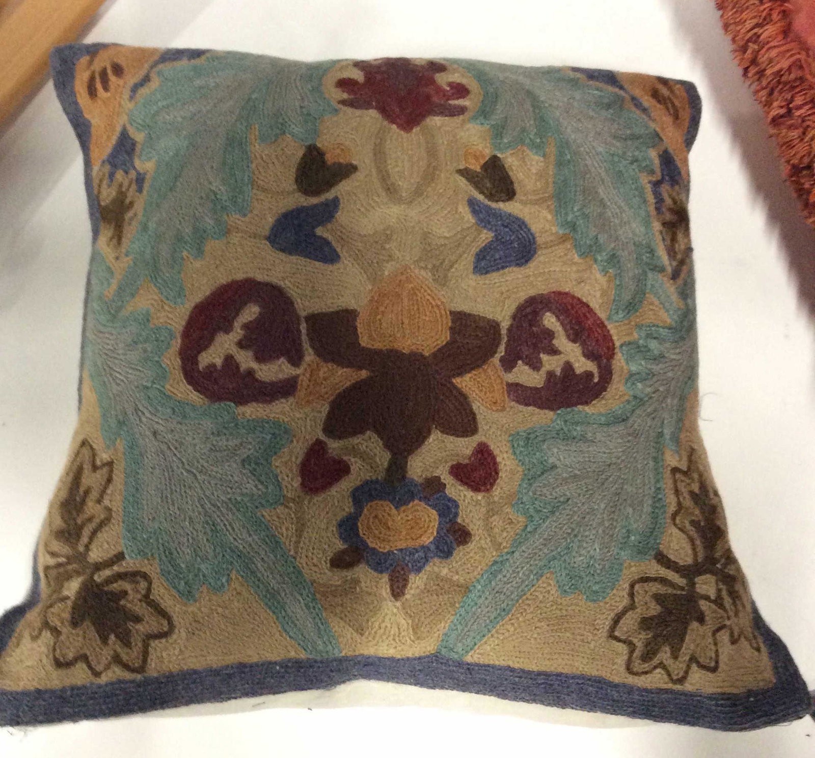 SHYAM AHUJA Wool Yarn Throw Pillow: Designer made Pillow cover with regular pillow form. Removable cover. 16 x 16 in. Muted cool colors of blues, tan and maroon in laurel design. Designer label attached. Shyam AHUJA Wool Pillow, Wool Ya