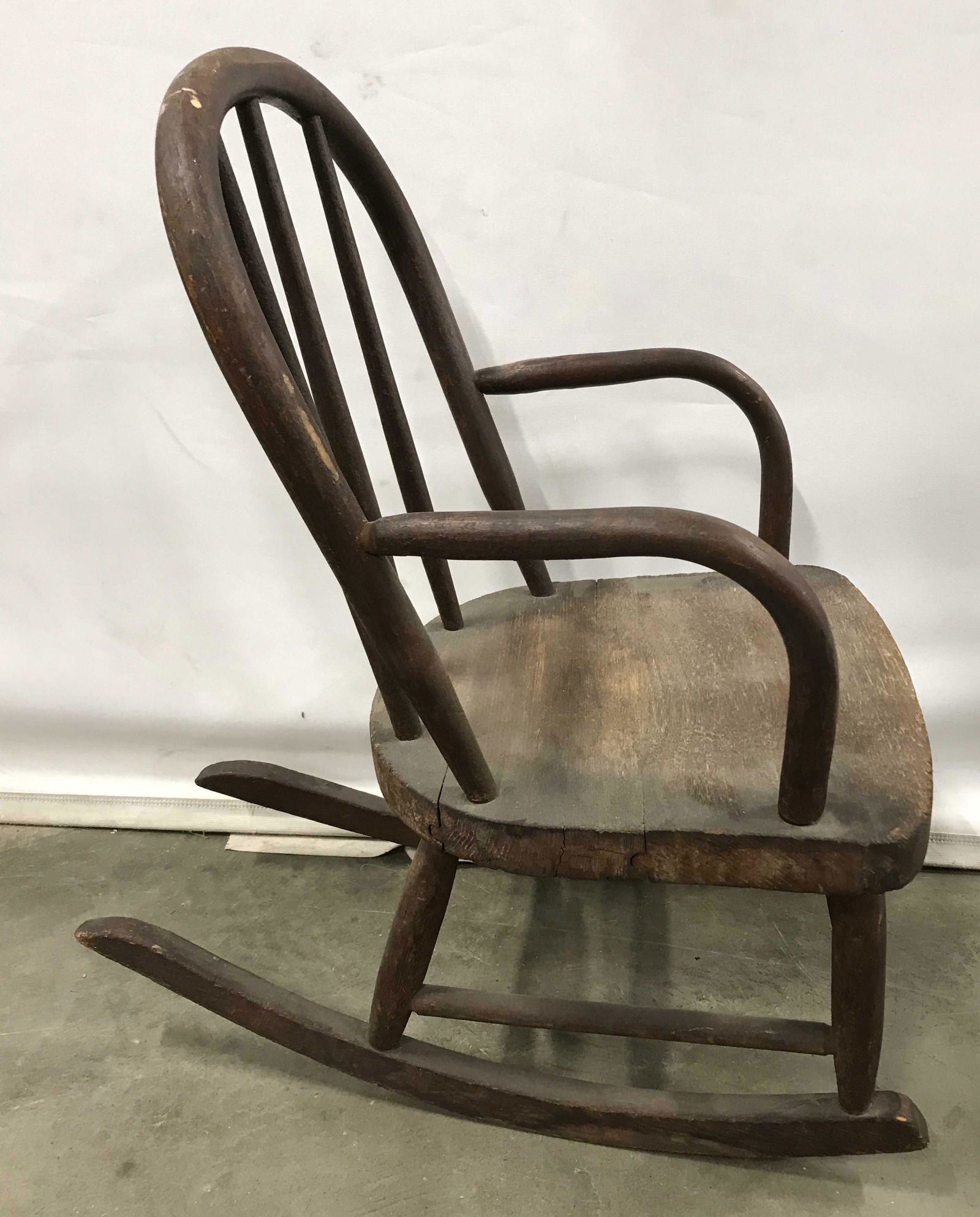 Antique Wooden Children’s Rocker: Carved wood rocking chair. Piece is antique. Measures approx 22.25 inches H, 13 inches W, and 12.25 inches deep. Wear is consistent with age and use. Vintage furniture, antique furniture, antique deco
