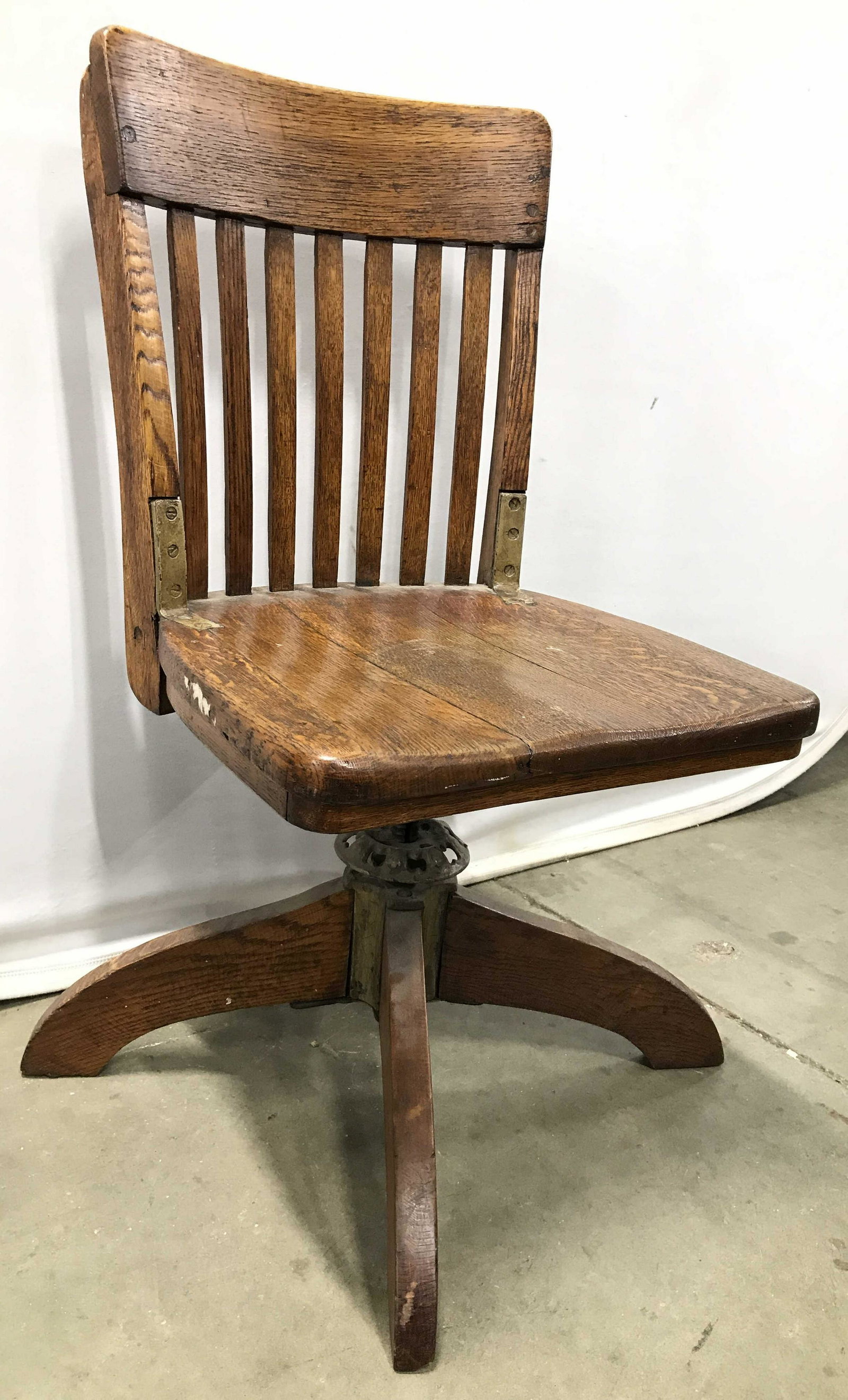 Antique Wooden Swivel Stool: Stool is wooden and antique. Chair has gold toned metal reinforcement on sides of backrest. Piece appears to possibly be hand crafted. Antique stool, antique chair, antique swivel stool, swivel stool,