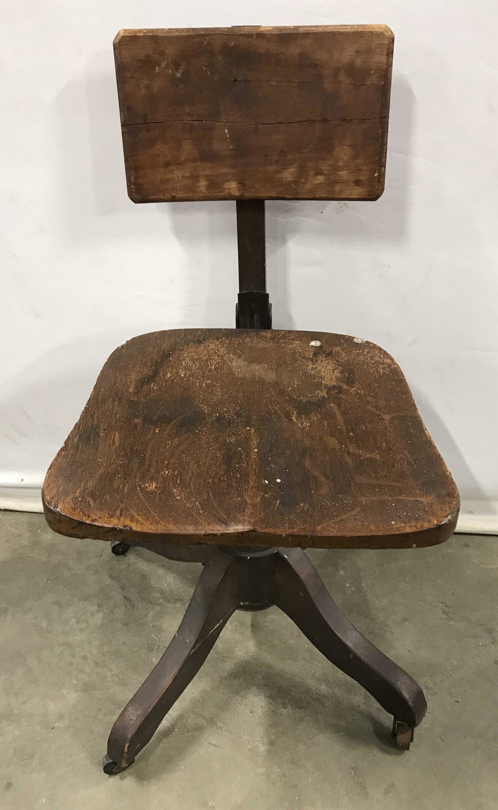 Antique Wood & Metal Swivel Stool: Antique swivel stool, crafted from carved wood and metal. X shaped legs are on castors. Measures approx 31.5 inches H, 15.5 inches W, and 18.5 inches deep. Wear is consistent with age and use. Vintage