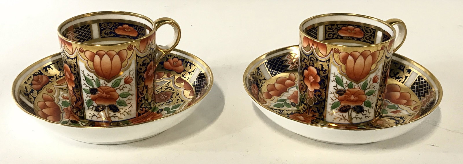 Pair Royal Worcester Imari Cups and Saucers, Eng: SIGNED And Hallmarked Royal Worcester Pair Tea Cups and Saucers. Heavy gilt, cobalt blue and orange flower and fruit motif. Saucers a slight bowl shape, 5.5 in diameter, cup 2.5 in diameter, 2 3/8 in