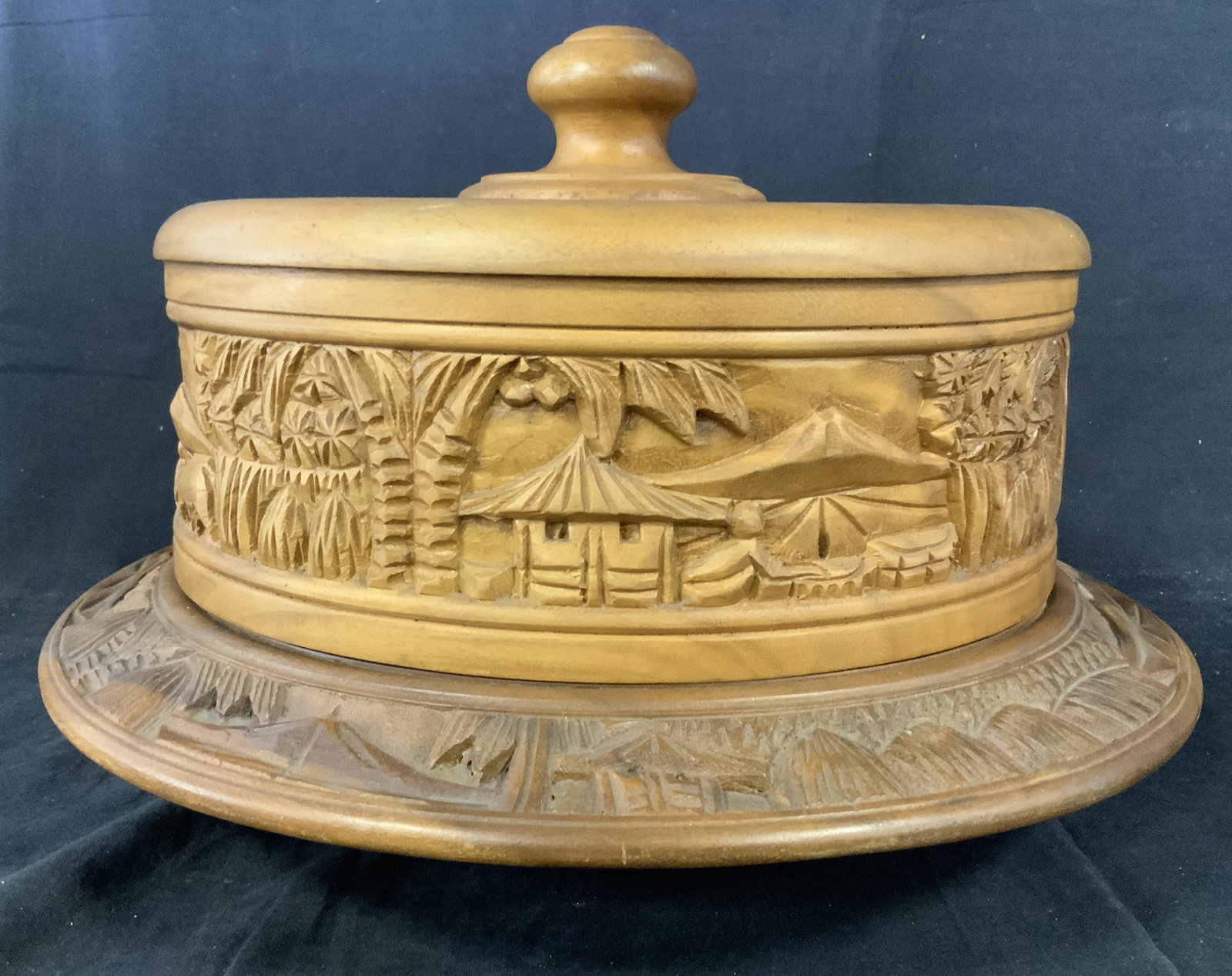 Rosas Wooden Lazy Susan Cake Stand: Rosas Wooden Lazy Susan Cake Stand, label to interior of lid reads ‘Rosas Philippine Handicrafts Balibao Angeles City Philippines tel 3156’, has images of huts and tropical trees, hand carved, rev