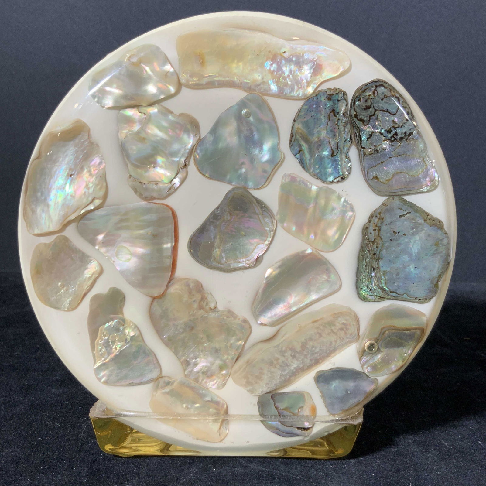 Vintage Napkin Holder w/ Lustrous Shells: Vintage round napkin holder that has assortment of lustrous shells, possibly bakelite. Shells glimmer & shine in the light. Shells possibly abalone. Slight discoloration on inside. Approx. 5.5 in. hei