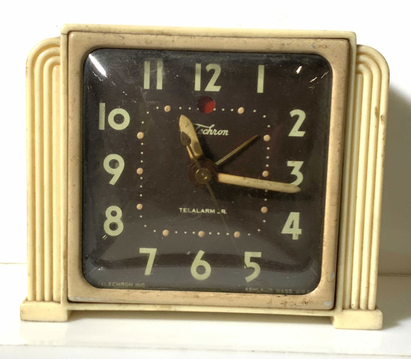 Vintage Collectible Telechron Electric Alarm Clock: Vintage Telechron alarm clock with beige exterior and brown clock face. Clock face reads: Telechron, Telalarm JR. Back of clock reads: Telechron Electric Clock. Detailed instructions on how clock func