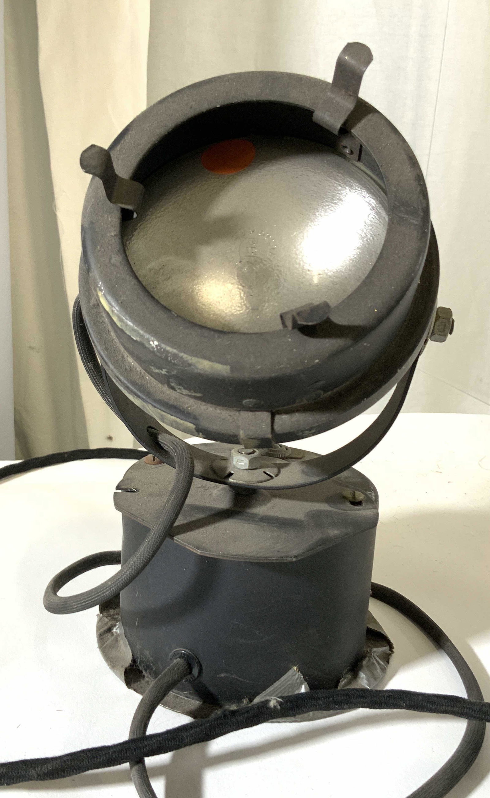 Collectible Vintage Studio Light: A vintage studio light used for lighting up stages. Weighted object. Long cord. Untested. Approx. 10 in. height Approx. 4 in. diameter Property of NYC Costume Designer Estate. Vintage studio light, li