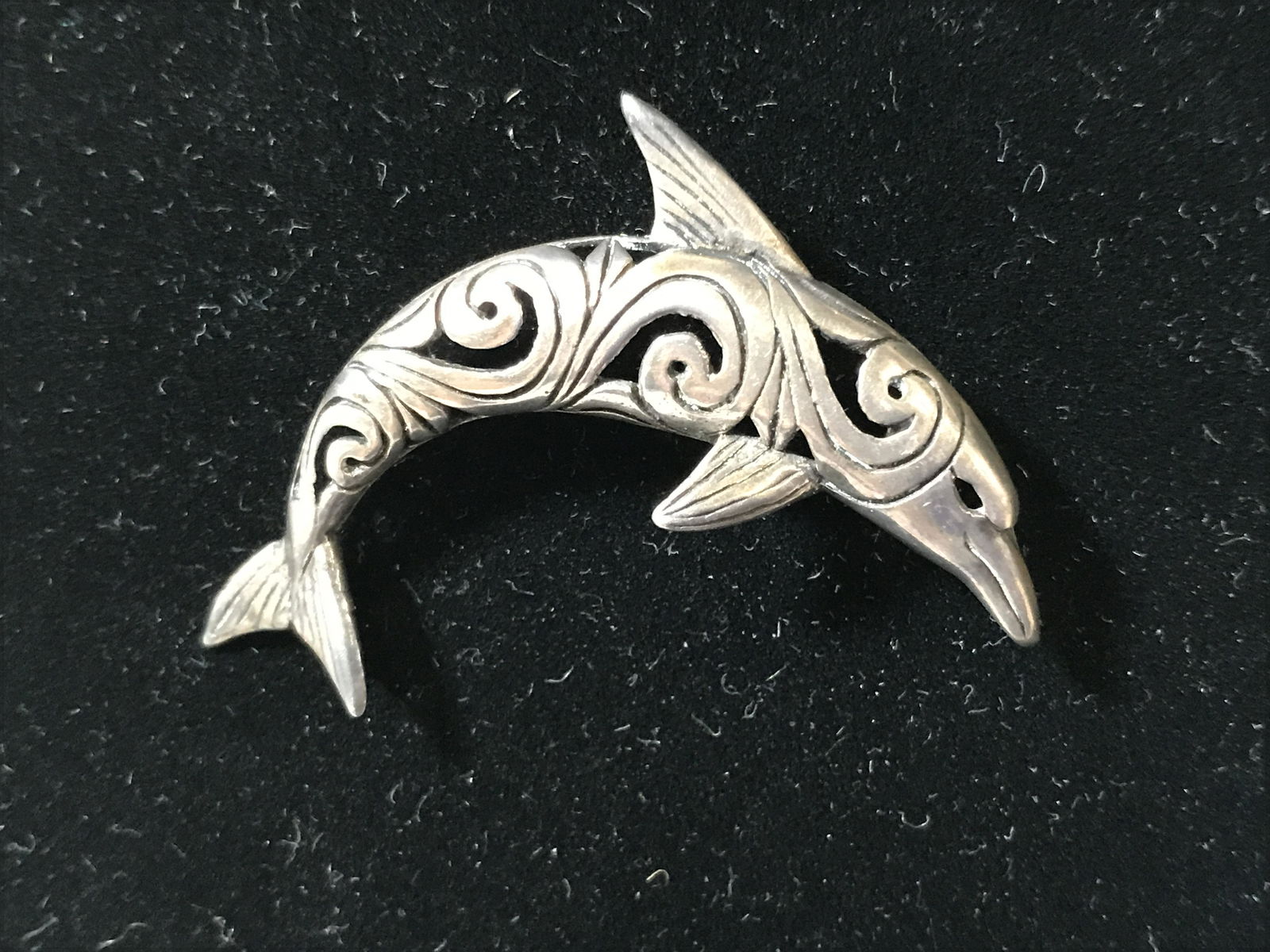 Silver Toned Metal Dolphin Broach: Silver Toned Metal Dolphin Broach, Dolphin has openwork wave style design, pin back has movable lock to keep latch in place, measures 1.75 inches long, overall in good condition, Silver toned metal, b