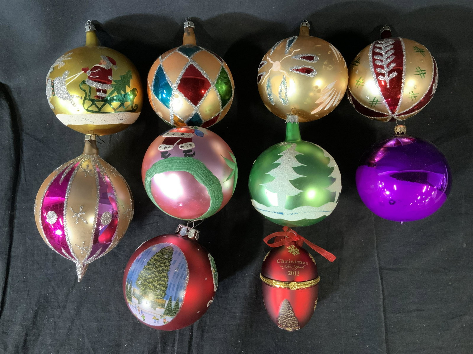 Lot 10 Glass Christmas Ornaments: Lot 10 Glass Christmas Ornaments, inscription to two red ornaments reads ‘Christmas In New York 2012’ and ‘Chez Christmas in New York 2011 65th St’, ornaments have various Christmas themed dec