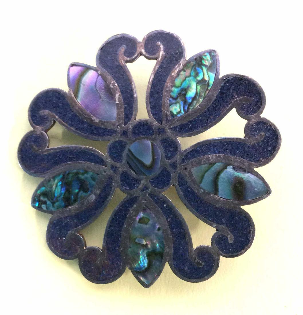 Pierced Abalone Sterling Silver Brooch: Medallion Style, inlaid Abalone And Crushed blue stone ( possibly lapis) . Verso stamped .925. App 1.5 in diameter. Doubles as a pendant. Sterling Silver Brooch, Estate Accessory, . 925, Crushed Stone