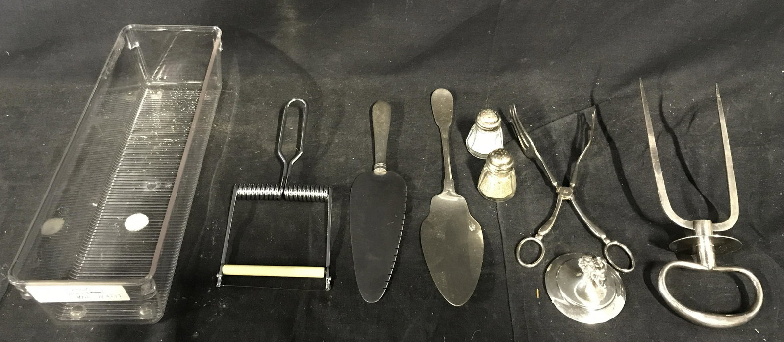 Group Lot of Kitchen Supplies: Group Lot of Kitchen Supplies, lot includes 8 different pieces including a salt & pepper shaker, a lid, a serving spatula, a cake knife, a pair of tongs, a meat skewer, and possibly a pasta tool, come