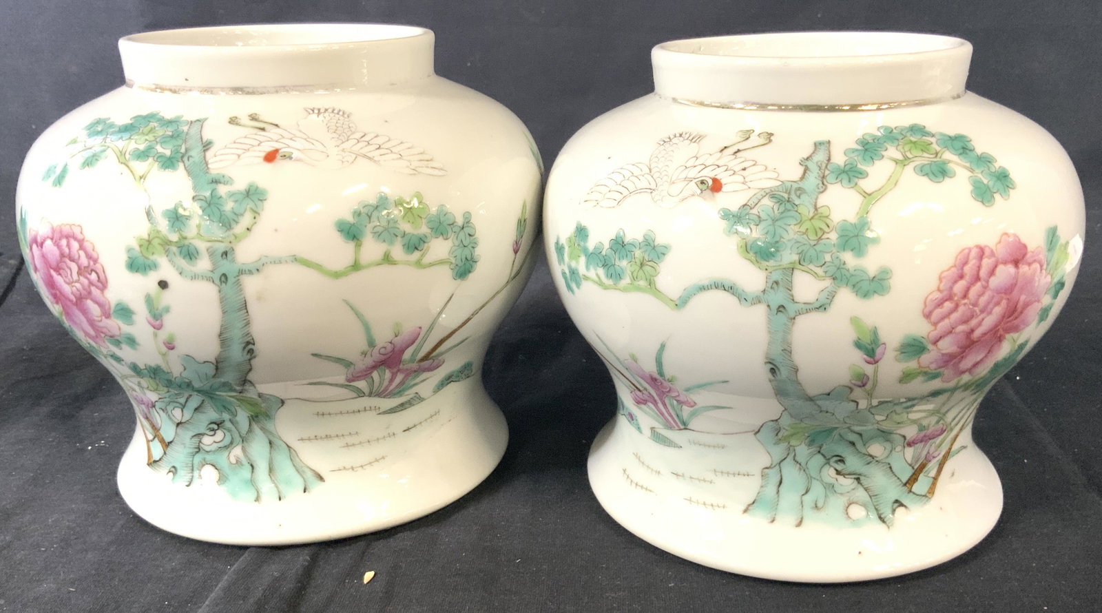 Pair Chinese Famille Rose Porcelain Vases, signed: Vintage vases of white porcelain, with light pitting indicating an older piece. Hand painted Relief paste- up of pink famille rose on green and aqua colored branches with bird in flight. Partially sig