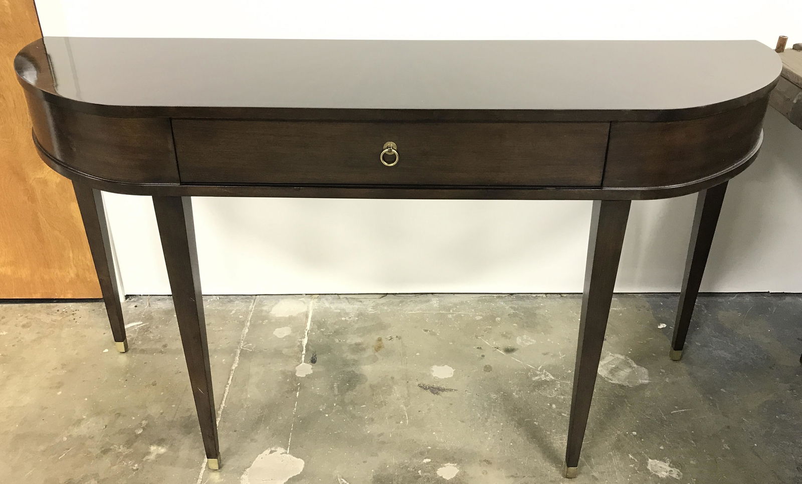 Walnut Toned Console Table: One drawer console table, drawer pull is brass, possibly vintage. Drawer joints are dovetailed. Four square legs taper off to polished metal feet. Table measures approx 32.75 inches H, 60 inches W, an