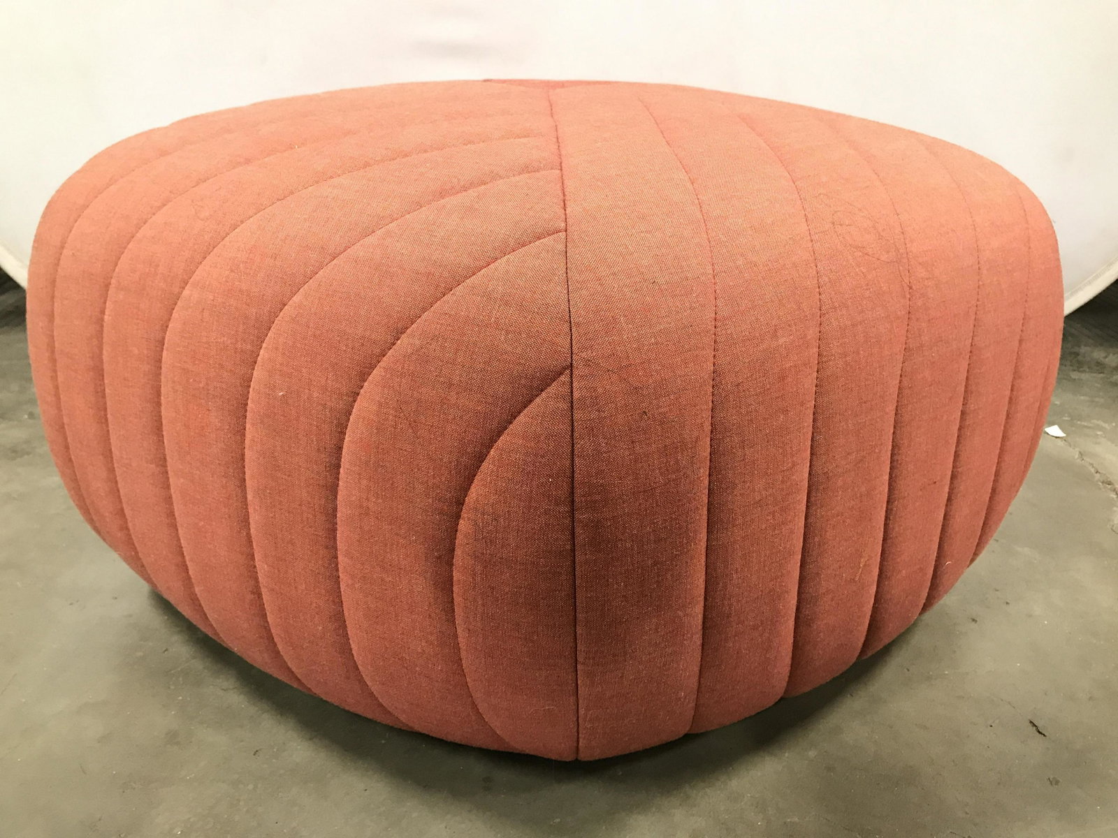Mid Century Modern MUUTO Remix 5 Pouf: Pouf is MUUTO. Piece is tangerine toned. Piece has crossed upholstery. Mid century modern, Danish modern, mid century modern pouf, Danish modern pouf, remix 5 pouf, MUUTO pouf, MUUTO ottoman, ottoman,