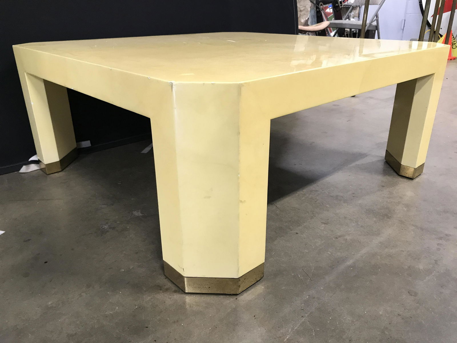 KARL SPRINGER MID CENTURY MODERN Coffee Table: Coffee table is yellow toned. Piece has mid century modern style. Piece has gold toned metal feet, possibly brass. Possibly Lacquered Goatskin Piece measures approximately 42 inches wide & deep 18 inc